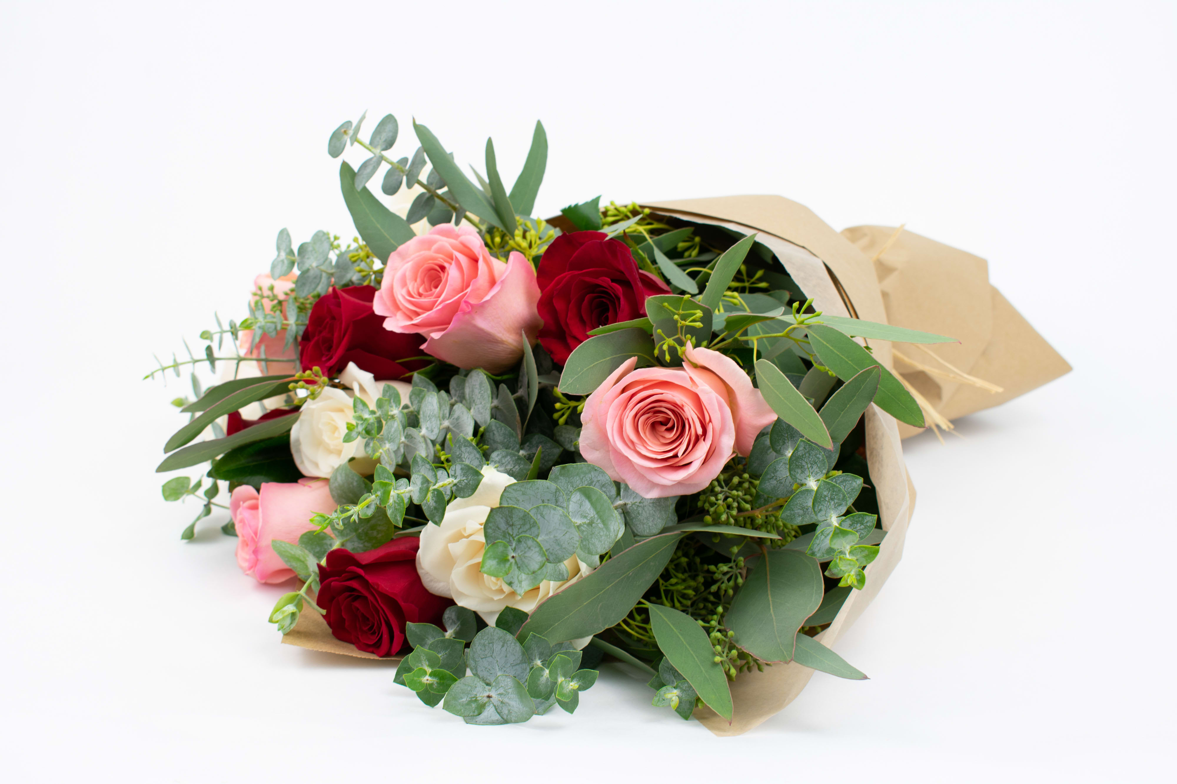 Blushing Beauty - RED, PINK &amp; WHITE ROSE BOUQUET   Dreamy and romantic. This pretty little rose bunch combines a trio of colors in ruby red, soft pink and creamy white. Sprigs of silvery eucalyptus complete this gorgeous rose gift beautifully.  These flowers are perfect for people who are romantics at heart and love lashings of luxury.  Send this lovely trio of roses to say happy anniversary or as a romantic gesture. They also make a beautiful thank you or happy birthday gift idea.  Why not add a greeting card, bunch of local dried lavender or quality handmade candle to match the occasion or personality?  Blushing Beauty features: ·        Red roses ·        Creamy Vendela roses ·        Creamy pink Novia roses ·        Seeded eucalyptus ·        Spiral eucalyptus ·        Kraft brown paper gift wrap  SIZE: The STANDARD flower arrangement is approximately 14” height and 14” width.   ALLERGY ADVICE: This design has low pollen and a low fragrance.   FAQ Q: What time will my flowers arrive and what if no-one is there to accept them? A: Excellent question! We’re unable to provide or guarantee specific delivery times. All our flowers are delivered anytime between 9-5pm, with exception to Sympathy designs for a funeral service. For full details around our delivery process and timings, please see our Terms and Conditions. Q: What days do you deliver flowers? A: All our flowers are available for San Francisco and Daly City delivery seven days a week, between 9am-5pm. Q: May I order for the same day delivery? A: Yes, same day deliveries are available if you place an order before 1pm. Q: May I request to change the design a bit? A: Yes, please make a note in the SPECIAL INSTRUCTION box when you place your online order. We will do our best to follow them. Q: Will my flowers look exactly as what is pictured? A: Depending on the season, colors or shades may vary. Sometimes we need to substitute flowers due to seasonal availability, but they’re always substituted for the same or greater value.   Ready to bring floral beauty into someone’s world with this bouquet of red, pink and white roses? Order this gift online now or give us a call on (415) 752-2060 if you have a question or special request. 