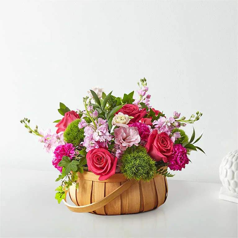FTD RADIANCE IN BLOOM BASKET - RADIANCE IN BLOOM BASKET  Inspired by bright shades and soft textures, this arrangement will wow your loved ones with its mix of roses, carnations, and lisianthus in a woven basket.