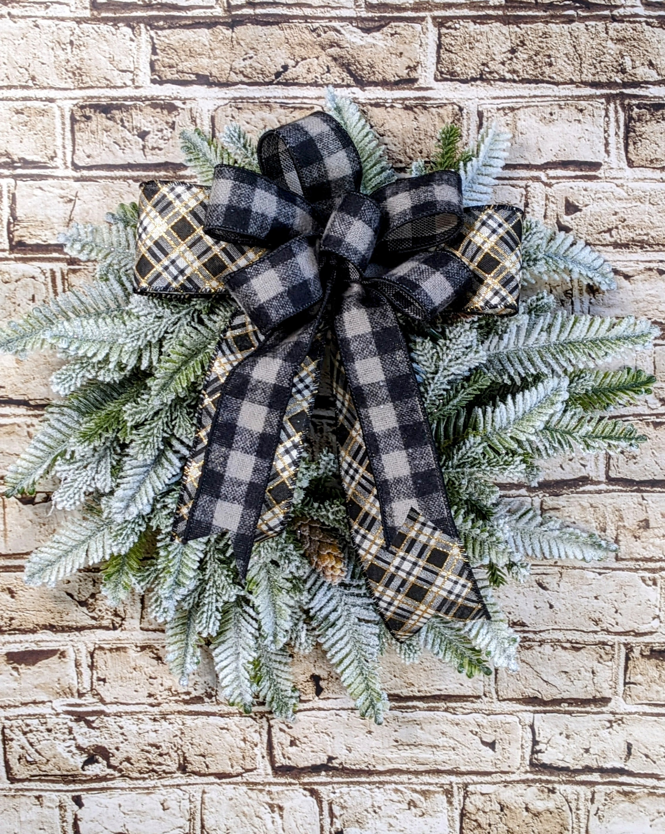 Chic Flocked Wreath - 14&quot; Artificial - A 14-inch artificial flocked wreath that beautifully captures the essence of winter with its soft, snow-dusted greenery. The wreath is elegantly adorned with black and white ribbon accents, creating a striking contrast that adds a modern, sophisticated touch. Perfect for adding a chic and festive statement to your door or wall, this wreath combines the beauty of winter with a stylish, timeless design.  Approximate Dimensions: 14&quot; Diameter