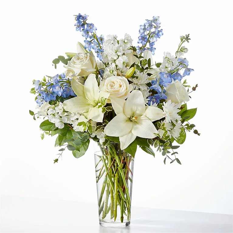 FTD PEACE OF MIND BOUQUET - PEACE OF MIND BOUQUET  White roses, delicate delphinium, and blooming lilies come together for a luxurious and elegant arrangement for any occasion. 