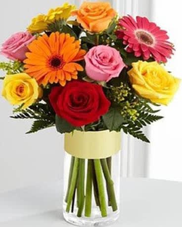 Elevate Me - Bouquet was designed to turn any day into one your special recipient will always remember with its bright and vibrant blooms. An assortment of roses and gerbera daisies in brilliant pink, orange, red and yellow hues is beautifully arranged amongst stems of yellow solidago and fresh greens, seated in a clear glass vase, to create a wonderful way to spread joy and happiness. 
