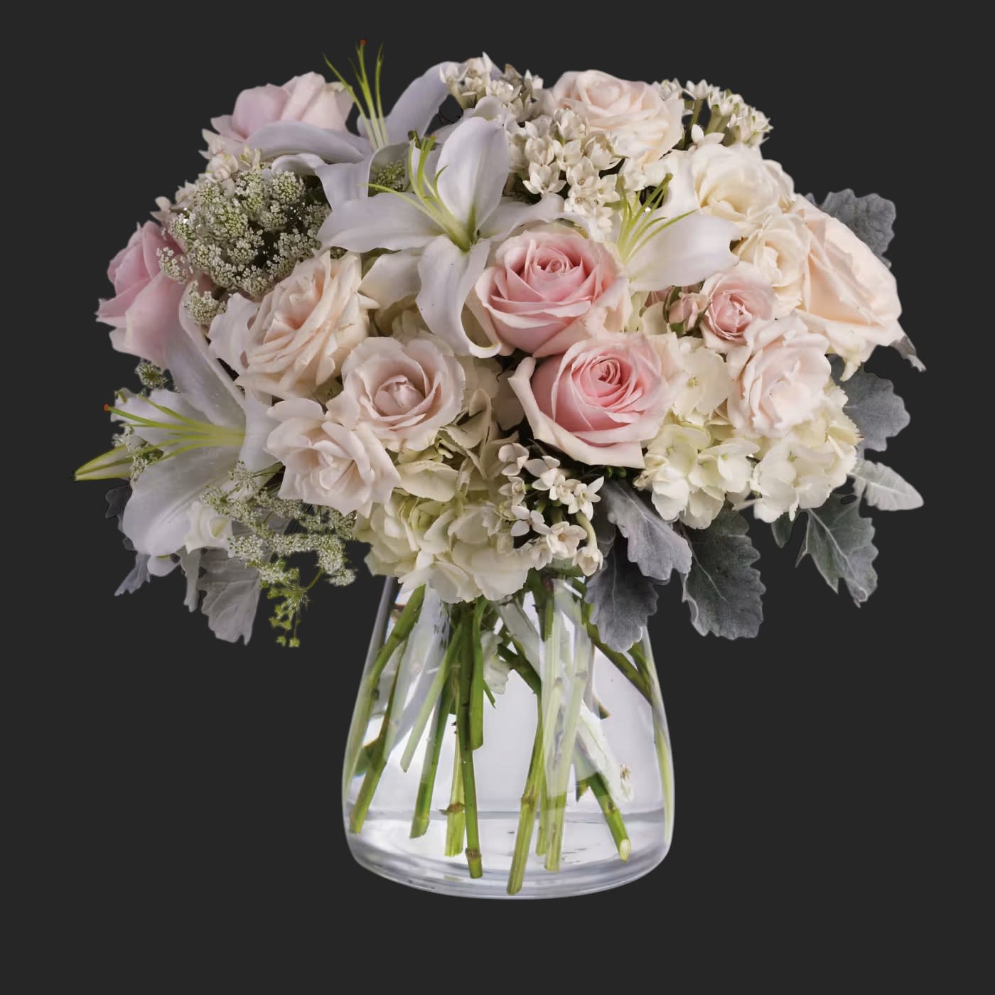 Beautiful Whisper by Teleflora - A whisper-quiet affirmation of love. Subtle shadings of pink and white roses, lilies and delicate Queen Anne's lace in a simple, elegant vase.    Gorgeous flowers such as white, crème and light pink roses, white oriental lilies and delicate Queen Anne's lace with a touch of silvery dusty miller, all in a classic hurricane vase.    Approximately 15 1/2&quot; W x 15 1/2&quot; H    Orientation: All-Around        As Shown : T237-1A    