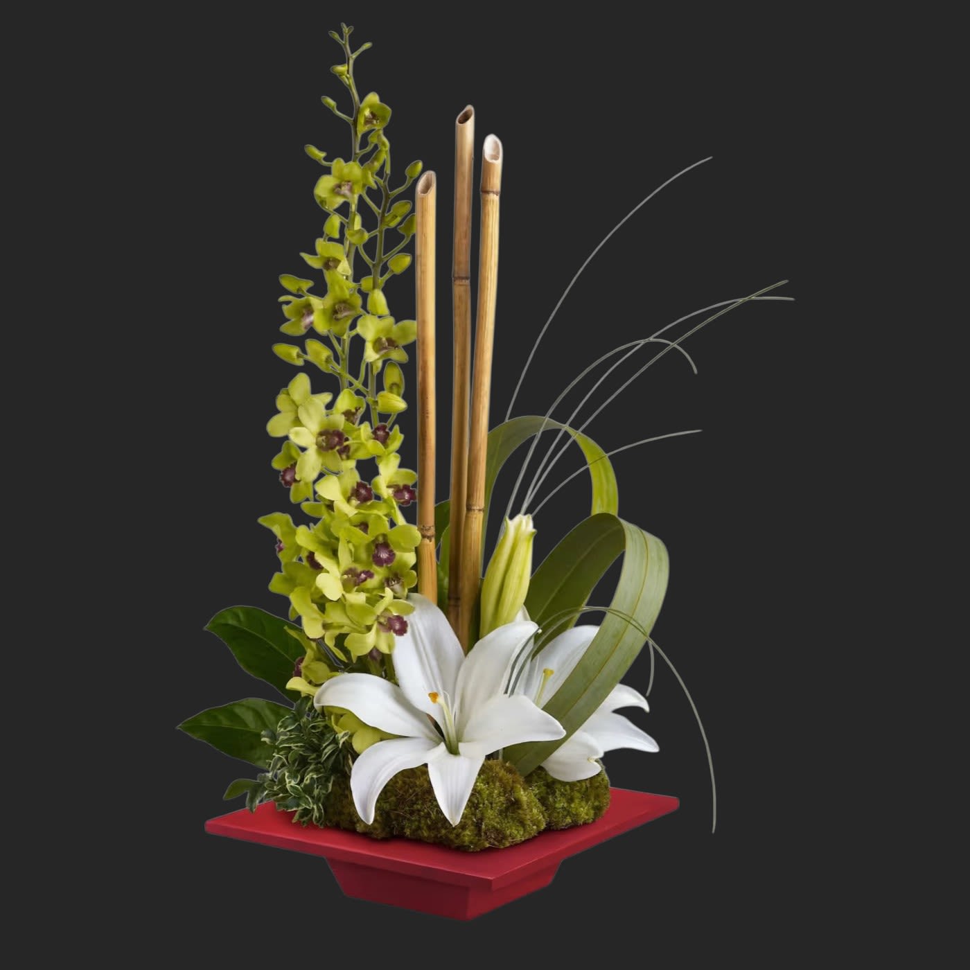 Teleflora's Secret Oasis - This lovely, serene bouquet makes a Zen-sational gift for any special occasion. They'll be thrilled with this artistic arrangement of orchids, lilies and exotic accents in a red bamboo dish. It's like a trip to Shangri-La.  