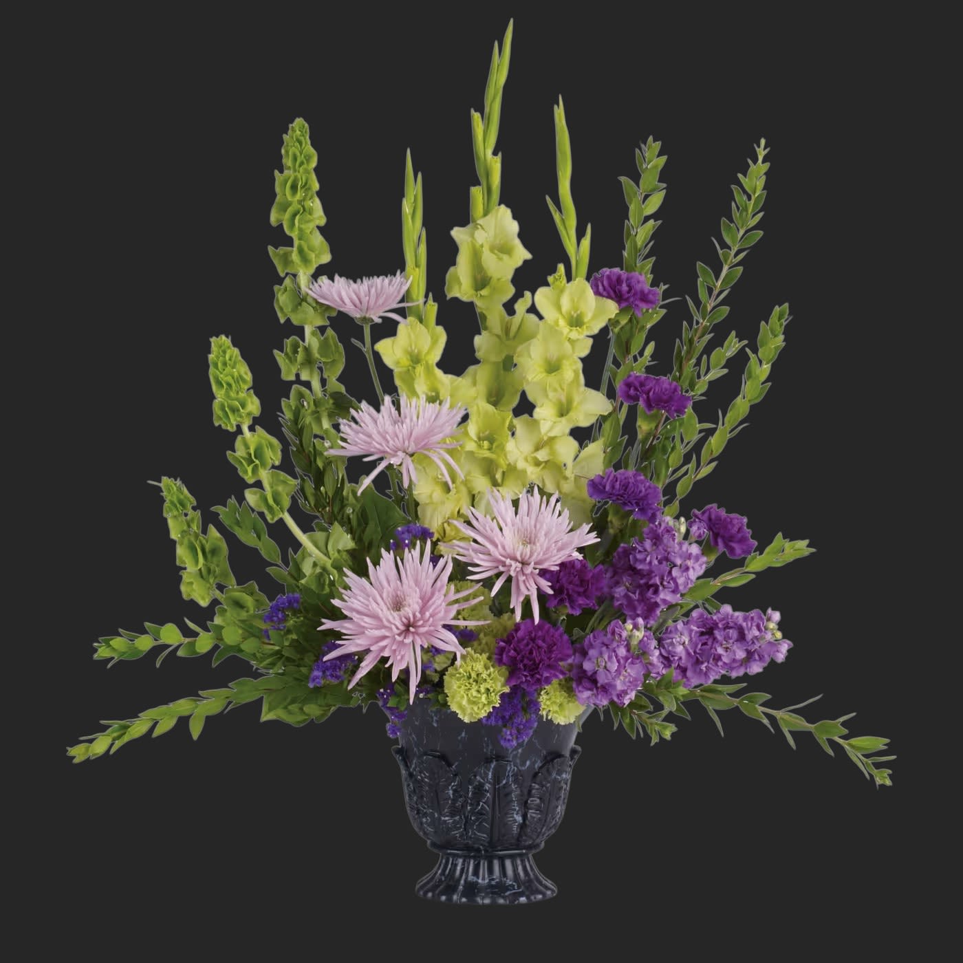 Teleflora's Cherished Memories  - This ethereally lovely bouquet of green gladioli, lavender stock, purple carnations and more in a timeless-tribute urn is a stunning choice for the memorial service.  