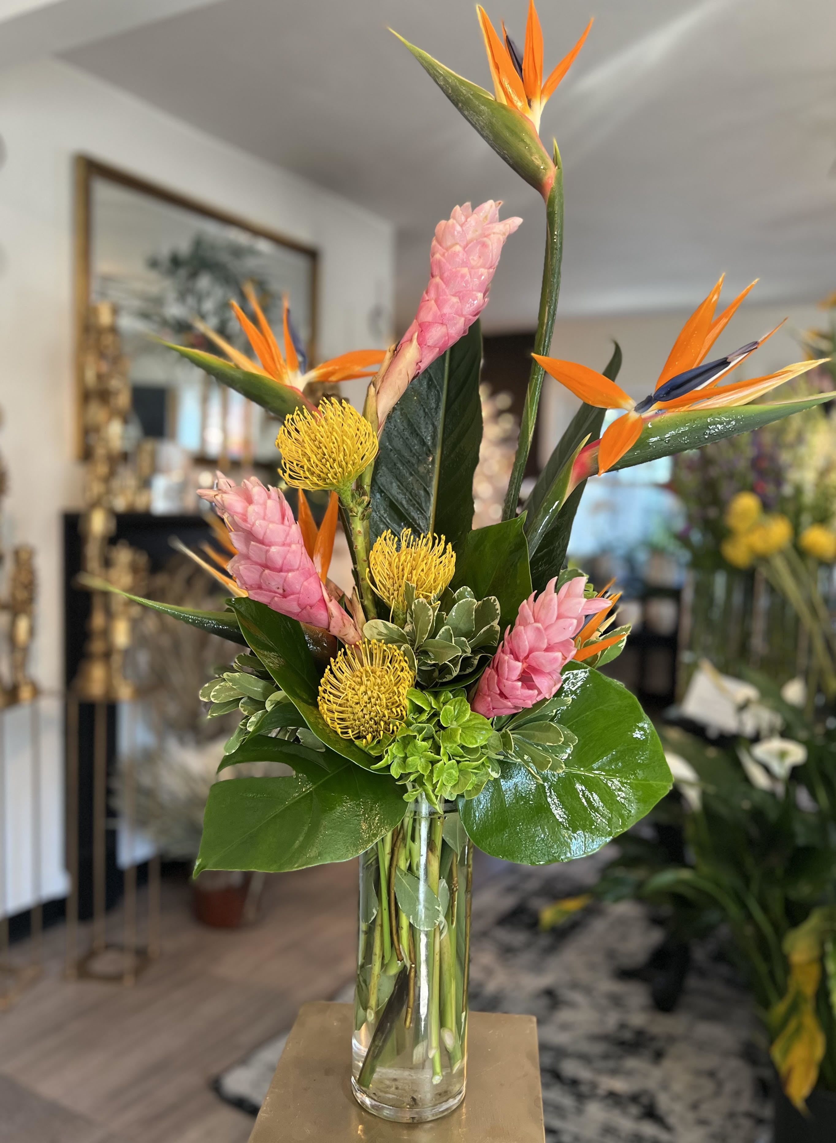 Tropical - Designer's Choice - An exquisite arrangement of our tropical blooms from our weekly Studio Theme.  Specific flower varieties and colors are not guaranteed. Each arrangement is delivered with a hand written card.  If you would like a more custom design, please visit our Custom Arrangement tab or give us a call at 757-355-5551!  *TIMED DELIVERY REQUEST WILL RESULT IN AN ADDITIONAL $10 CHARGE