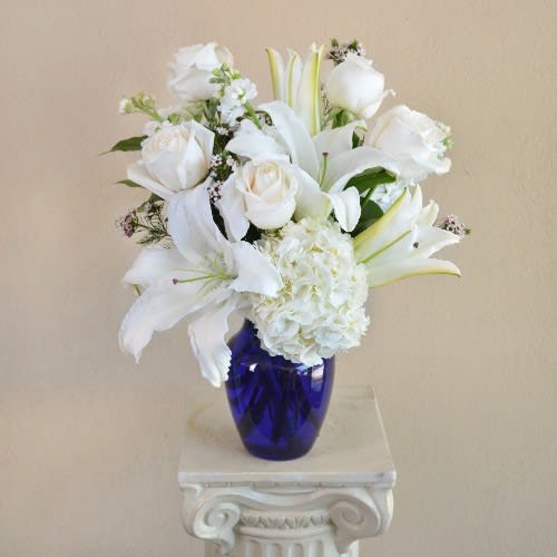 White Wonderland - White Roses, White Lilies and White Hydrangea in a blue vase