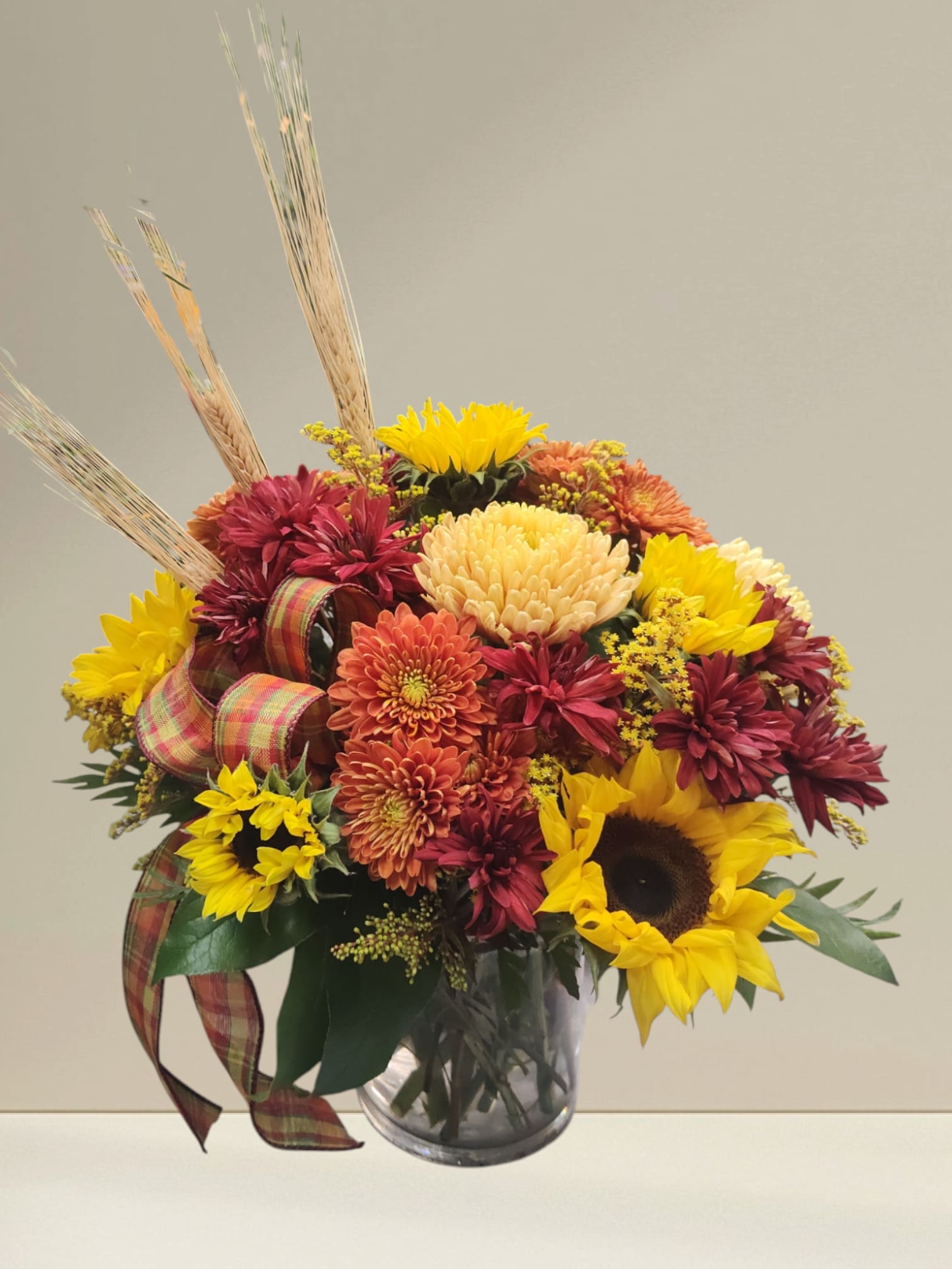 SPLASH OF FALL - BEAUTIFUL FALL ARRANGEMENT IN BRONZE AND GOD TONES. SUNFLOWERS AND MUMS GIVE YOU A SENSE OF WARMTH FOR THIS FALL SEASON.