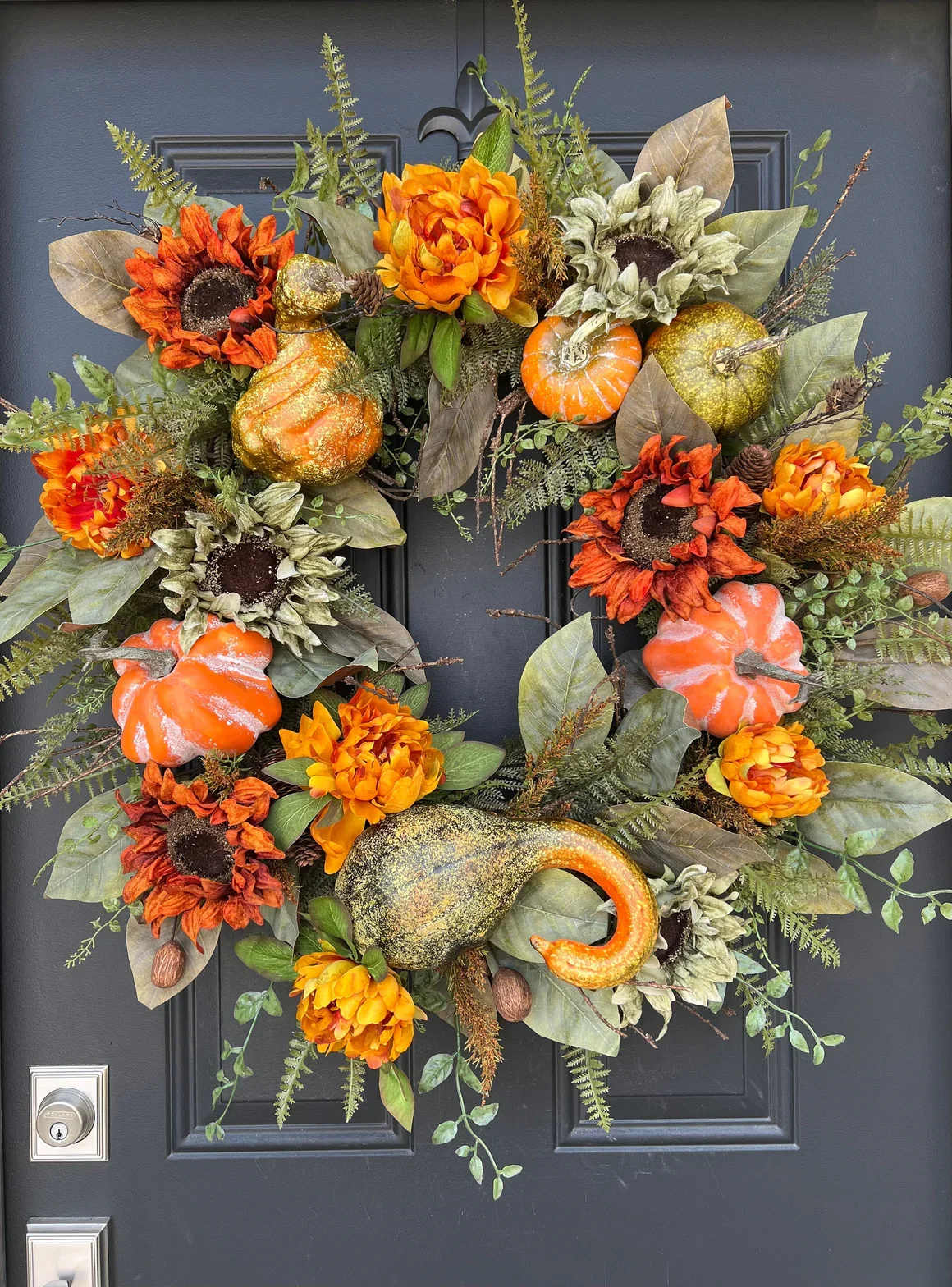 Harvest Pumpkin Wreath - Our Harvest Pumpkin Wreath is the perfect centerpiece for your fall décor. Adorned with realistic pumpkins, vibrant orange florals, and rustic greenery, it captures the essence of the harvest season — warm, joyful, and full of gratitude. Ideal for front doors, fireplaces, or as a seasonal gift.