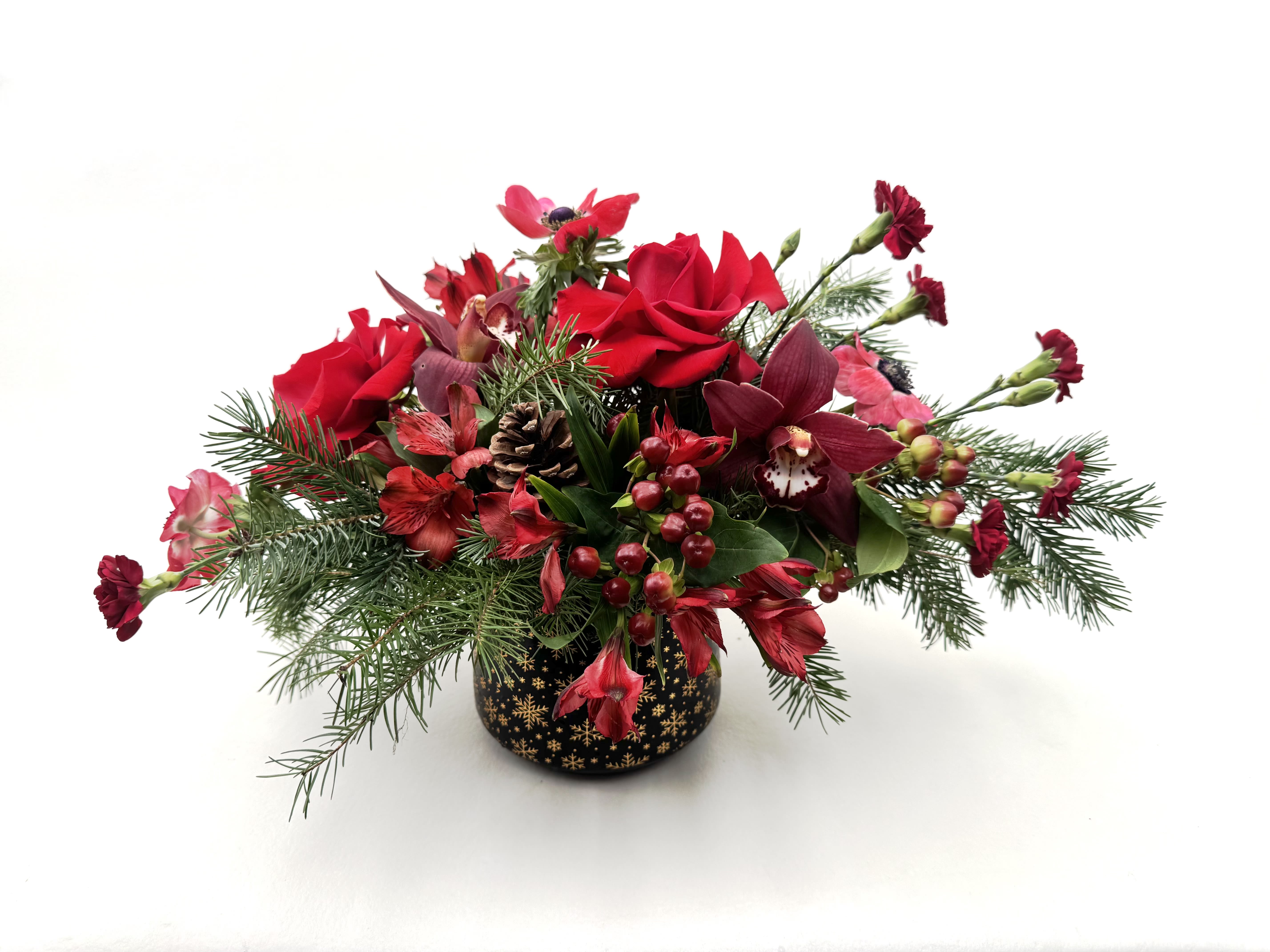 Krampus - Spice up your holidays with our Krampus arrangement! Sultry reds and winter greens are arranged in a black ceramic vase with gold accents.   Delivery Info- We make all of our deliveries after 1pm every day. If the weather is very cold, we prefer not to leave the flowers outside. Please let the recipient know that they should expect delivery