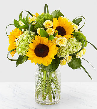 Stunning Sunflower Jar - Light up the face of your loved ones with a bouquet filled with warm, sunny sentiments. From bold sunflowers to green mini hydrangea and yellow spray roses, capturing the wonder of lush fields was the inspiration behind our Stunning Sunflower Jar. Completed with green trick dianthus and lily grass, this arrangement is perfect for saying, &quot;You make life brighter,&quot; or &quot;Your presence is radiant&quot;.