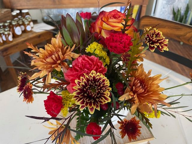 Holiday Pumpkin Centerpiece - Looking for the perfect gift this holiday season? These gorgeous blooms will arrive in a ceramic pumpkin perfect for reuse each season! 