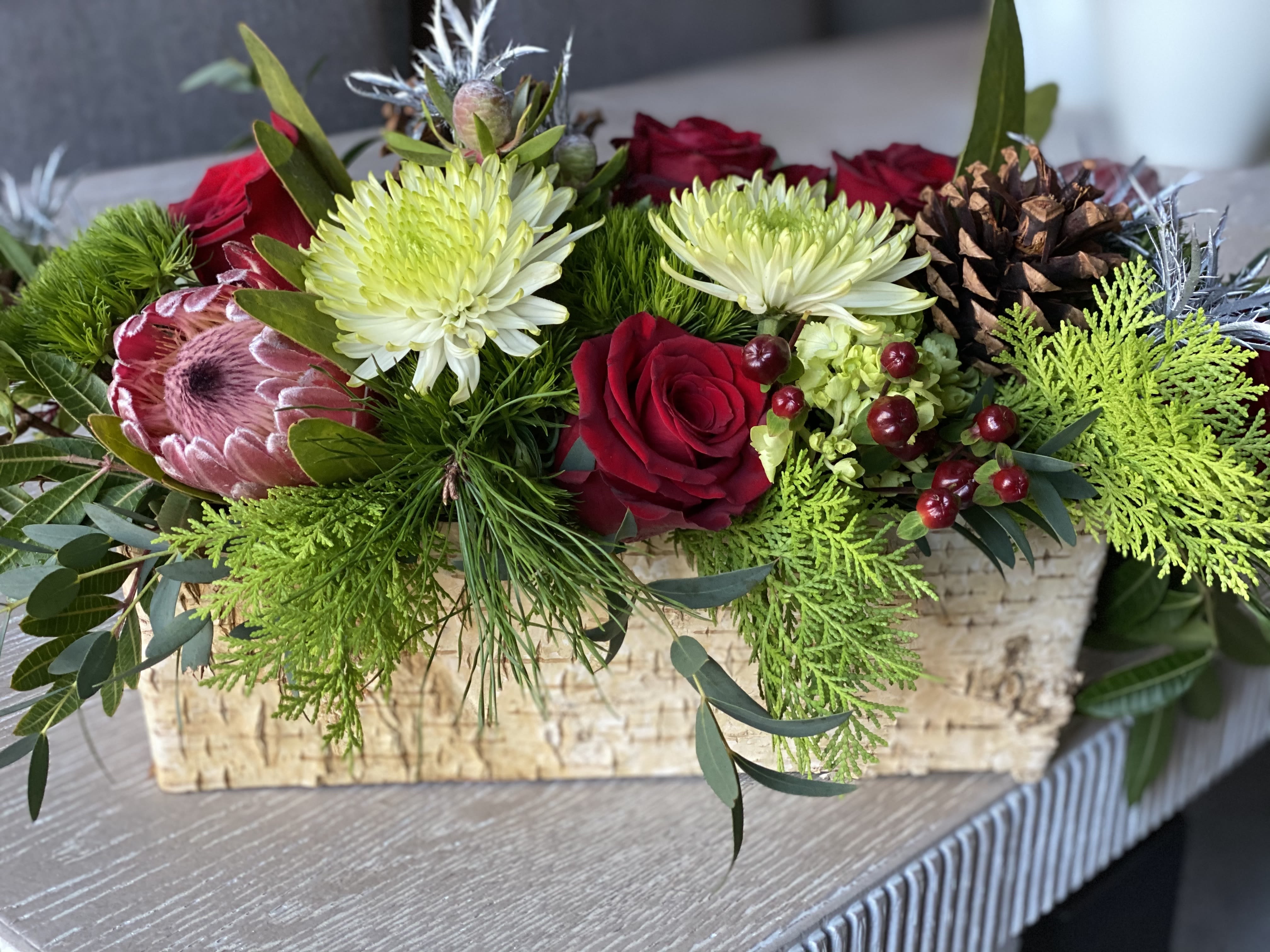 Box of Blooms Winter Designer Edition - We love designing with aged pine boxes- the flowers sit so beautifully and create a lush garden look that can add magic to any room.  Its timeless and a major hit with clients.   These boxes are great for holiday tables, coffee tables, foyers and make a gorgeous gift not only for holiday but for many celebrations! You can also plant in them after flowers expire- succulents and other small plants look great in these!   We will use winter colors for this and expect a mix of premium florals - ranunculus, roses, hydrangea, tulips, etc. We see what looks best at the market.   If you are looking for a specific color palette please indicate in the notes.  We can do this in whites/greens, reds, blues whites and just about any color pending floral availability.   Standard size is a Square- Aged Pine 6&quot;x6&quot; with flowers well exceeding vase size.  Deluxe is a Rectangle Pine - 10&quot;x 4.5 &quot; W x 4.5 &quot; D- we design the flowers well exceeded vessel size- expect florals to be approx 14&quot; in length Premium 1x square + 1x rectangle ( one of each) If you will need more for your table please order in quantities are send us your table spec for a custom order to hello@blossomstem.com oe 203 293 4275. These are extremely popular for holiday and sometimes we will sell out of vessels. Order early!  