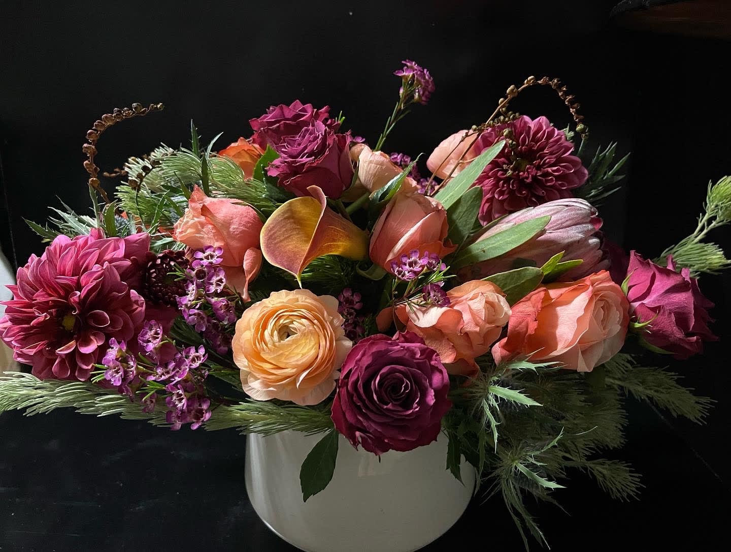 Modern Holiday designers choice. - Beautiful  design in a modern vase. We will design with the flowers of the day.  You can request certain flowers and colors...if we have them and match the pricing we will of course do what you've asked! :)