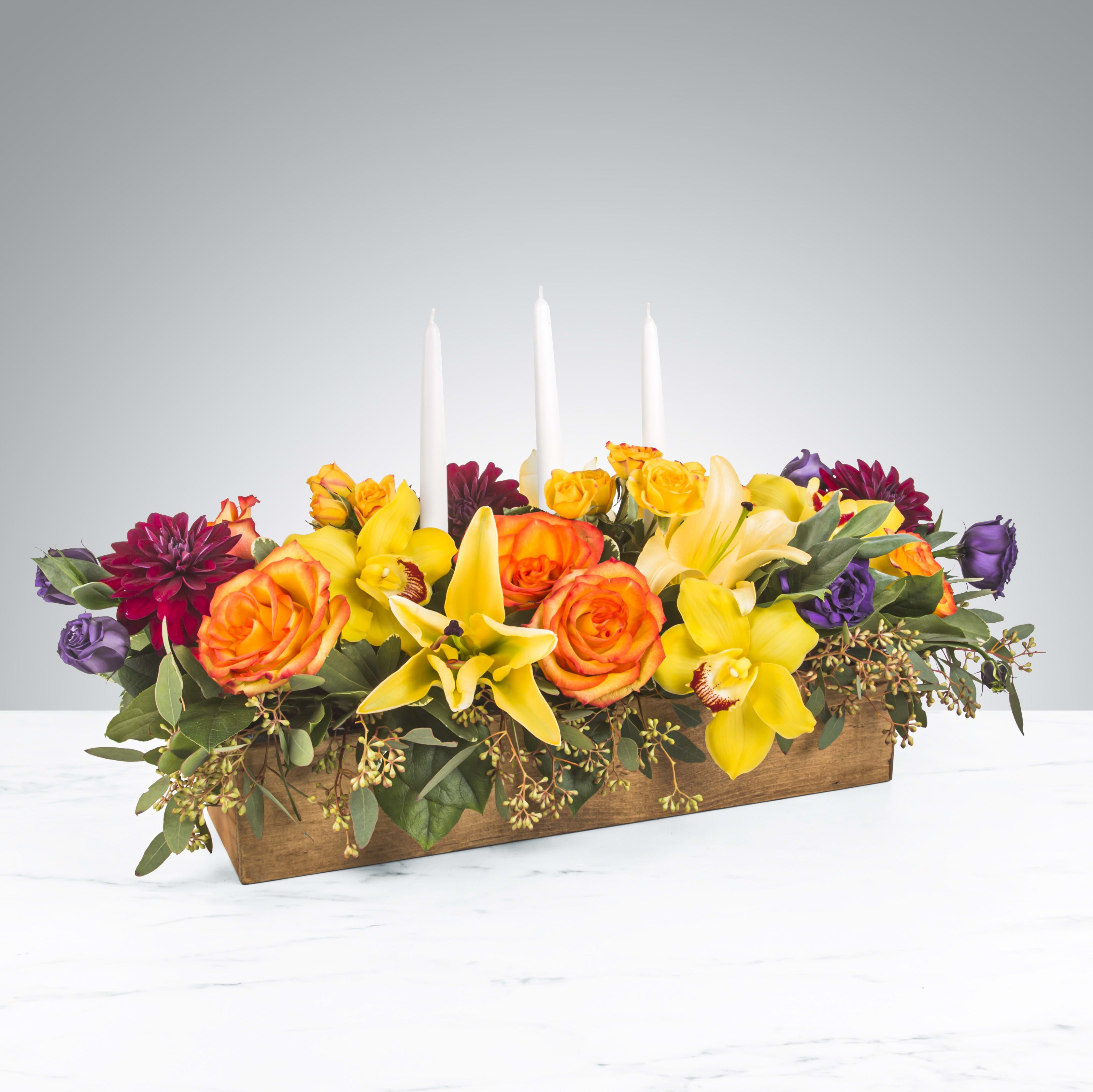 Full Harvest by BloomNation™ - No dinner party or food gathering is complete without a centerpiece and this large arrangement makes a big statement on any table. Featuring white dinner candles and a variety of flowers, dress up any event with this arrangement. Send it as a housewarming or thank you gift.  