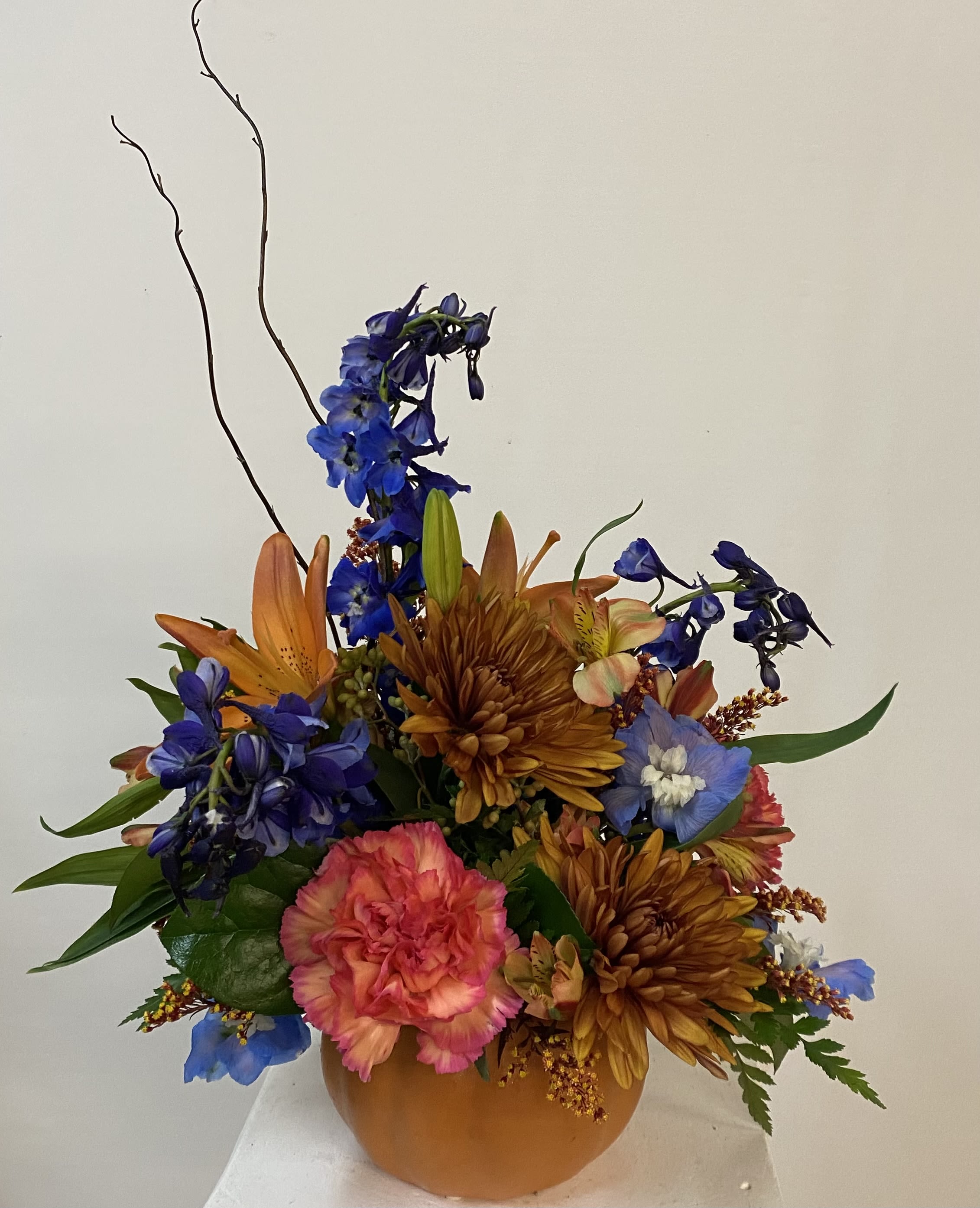 Autumn Pumpkin - Ceramic pumpkin filled with fall flowers chosen by our expert designers from our fresh seasonal flowers. Certainly a fabulous centerpiece for any gathering. 