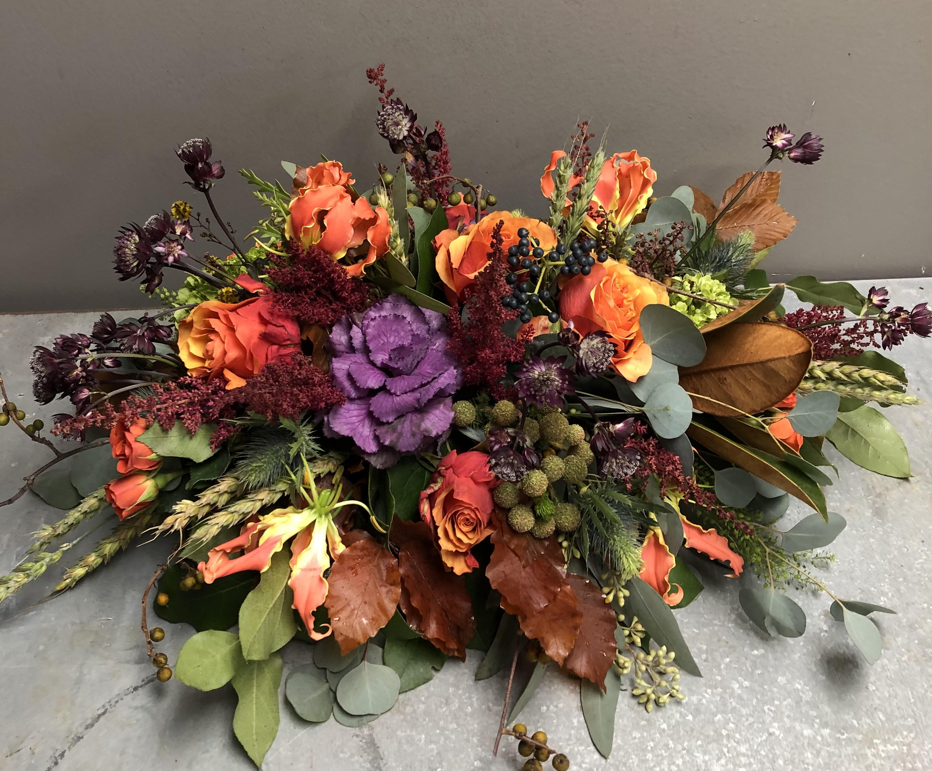 WHIMSICAL THANKSGIVING CENTERPIECE - Inspired by the ever-changing autumn landscape, this striking seasonal arrangement showcases vibrant color roses and whimsical accents that will be a beautiful addition to your Thanksgiving table.