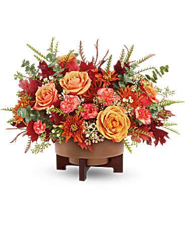  Modern Copper Centerpiece -  light orange roses, orange mini carnations, bronze mums, white waxflower, seeded and spiral eucalyptus, grevillea, and preserved oak leaves ****flower variety may vary based on availability ****