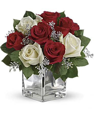 Snowy Night Bouquet -  Give Christmas a charmingly contemporary spin with lush red and white roses in a dazzling mirrored silver cube. With a merrily moderate price tag, it makes the perfect gift for all the people on your list - naughty or nice.      The impressive bouquet includes red roses and white roses accented with assorted greenery.     Orientation: All-Around 