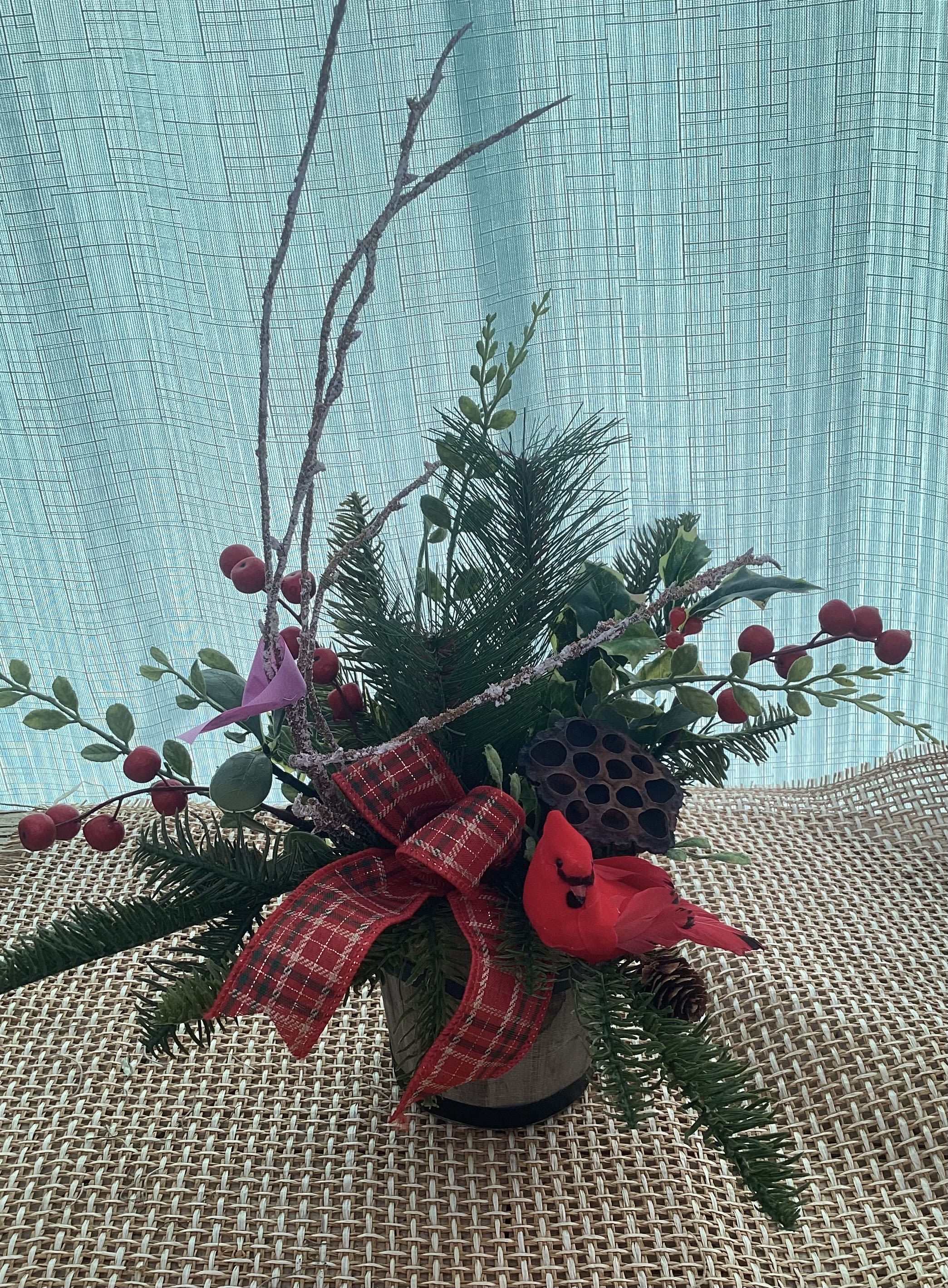 Holiday Cardinal Arrangement  - A holiday arrangement decorated with greenery and a Cardinal in the center