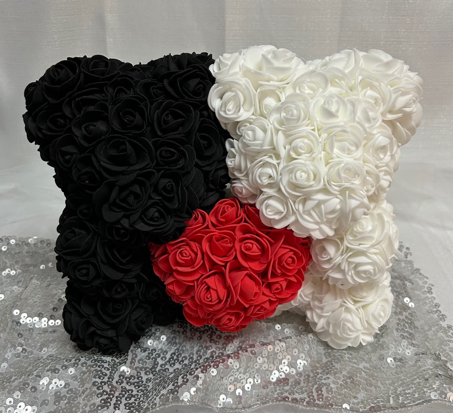 Sweetheart Double Faux Rose Bear White and Black - This 9&quot; x 11&quot; bear duo is covered in artificial faux roses with a red heart in the middle. 