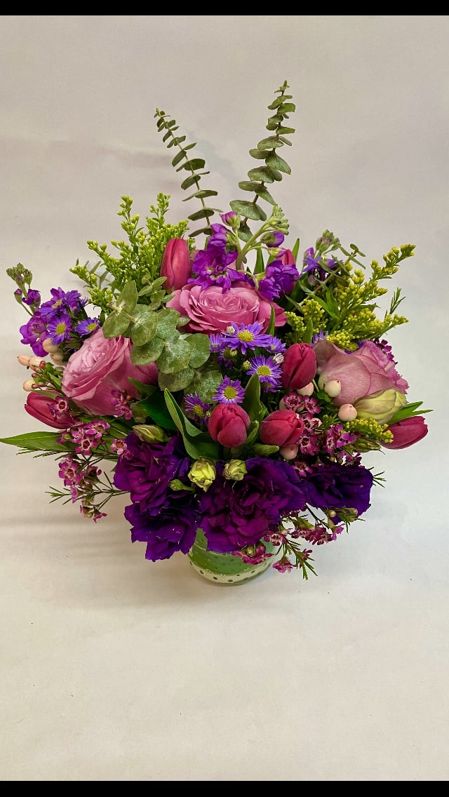 Sugar Plum Bouquet - This lovely and  heartwarming arrangement features Roses, lisianthus, tulips, wax flower, stock, aster, gerbera daisies, eucalyptus, hypericum, solidago, and variety of greenery. (Some flowers may be subject to change depending on the season. We will contact you with available flower substitutions; please contact us with specific questions if you are concerned with flower availability, thanks!) FEATURED ARRANGEMENT: $139.75 (REGULAR PRICE)