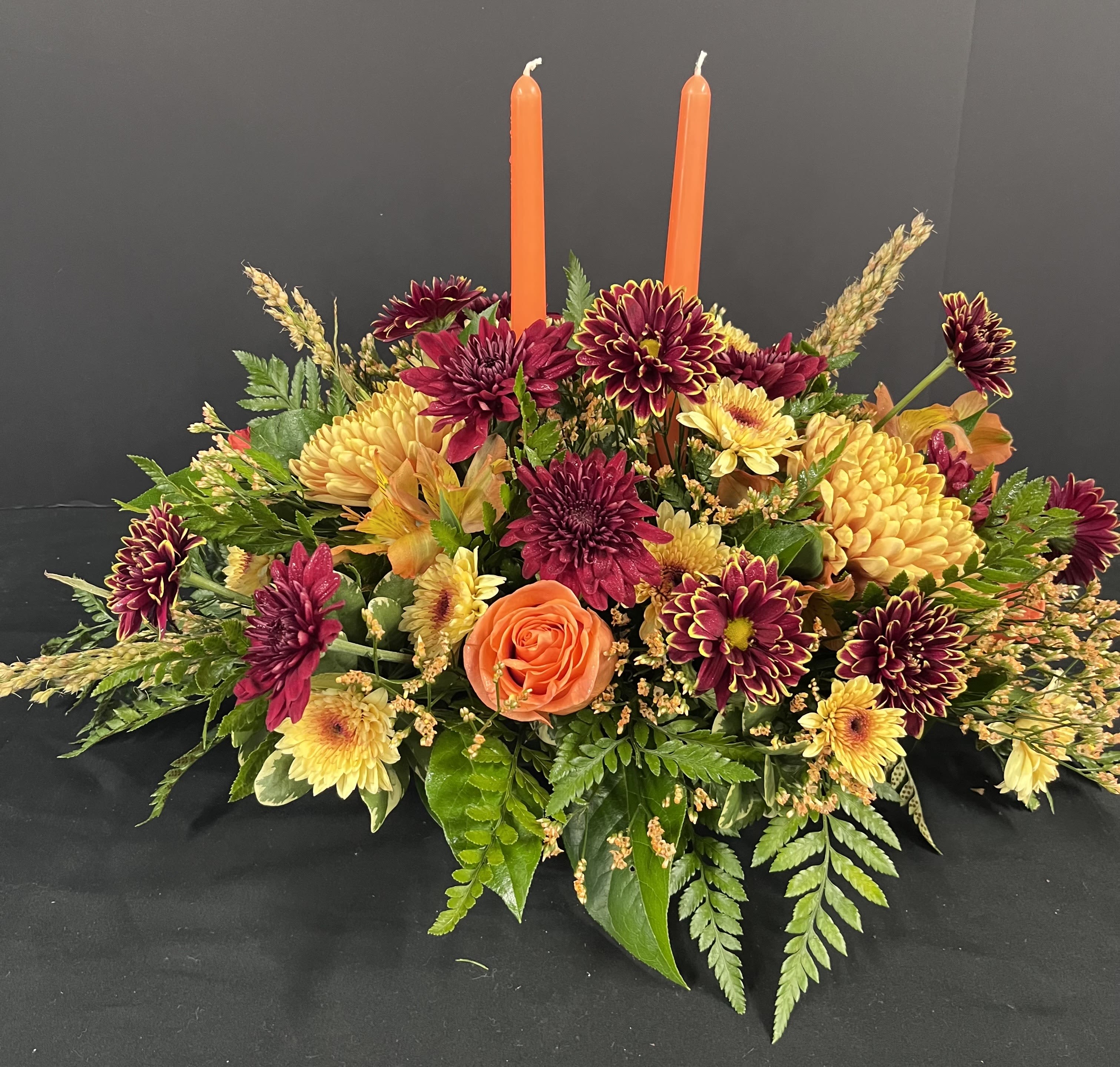 Festival Thanksgiving Centerpiece - Our festive centerpiece is created using the freshest blooms of fall.  Flowers may vary, but will be fall theme as the picture.