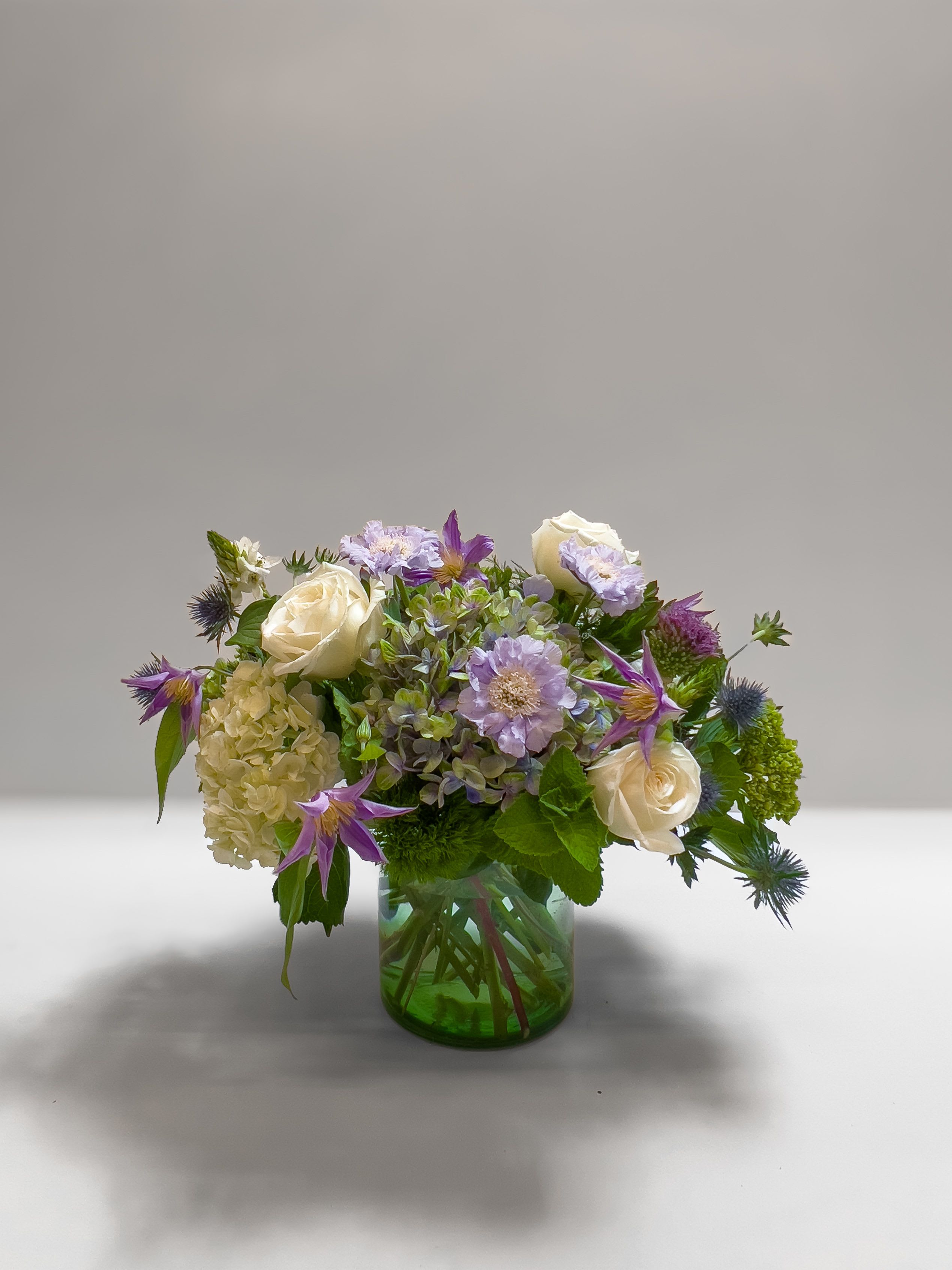 Claude's Garden - A soft arrangement inspired by Monet’s beautiful garden in Giverny. Filled with airy, pastel blooms, it has a natural, painterly feel—like a bouquet picked from an impressionist painting. Peaceful, romantic, and full of charm.