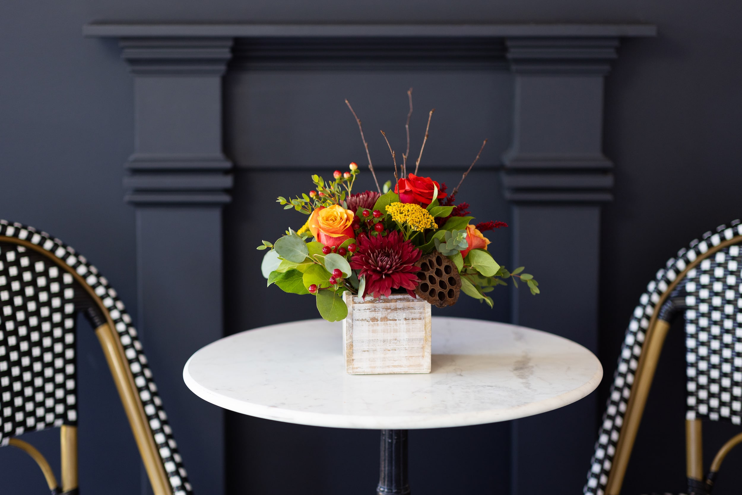 Grateful Collection Small Wood Box  - Our Grateful collection features a classic styling of festive fall colors like red, orange, yellow, burgundy and brown. Flowers include roses, mums, berries, twigs and dried lotus pods all beautifully crafted in a white-washed wood box. As a gift to show you love and appreciation or a lovely additional to your Thanksgiving feast.   Specifications: Arrangement is approximately 6&quot; wide and 9&quot; tall. 