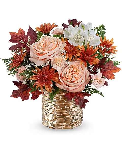 Teleflora's Sparkling Blooms Bouquet - Sparkling Blooms Bouquet glows with autumn beauty. Warm peach roses and fall blooms shine in a golden mosaic vase-perfect for Thanksgiving gatherings, seasonal gifts, or cozy home dÃ©cor. Sparkling Blooms Bouquet features peach roses, white alstroemeria, peach miniature carnations, bronze cushion spray chrysanthemums, and white limonium. Accented with leatherleaf fern and preserved oak leaves in a golden mosaic vase.