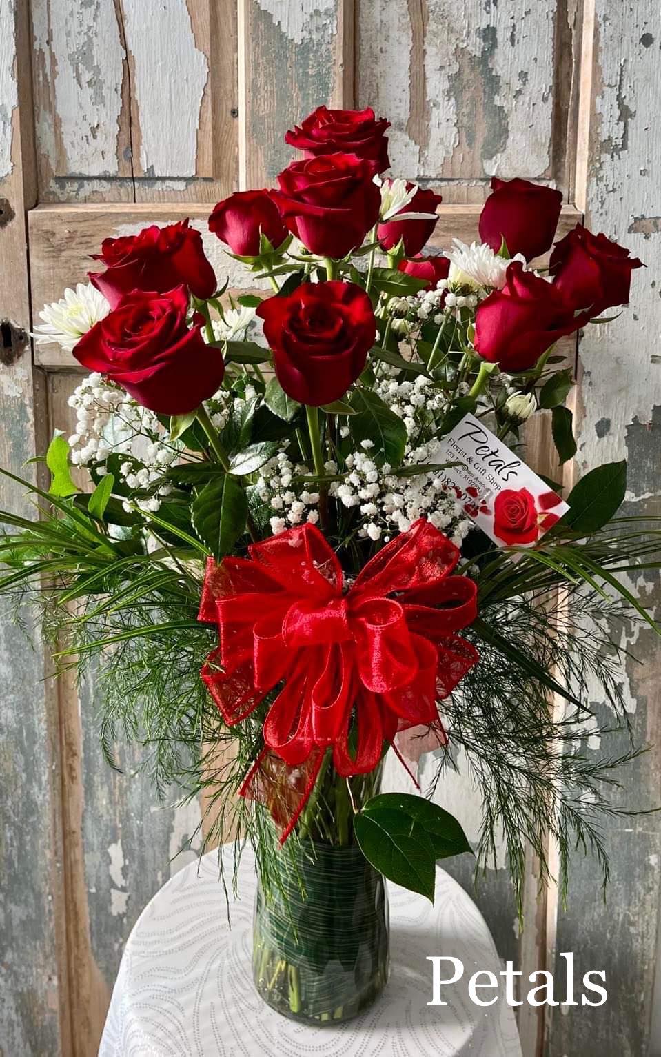 The Perfect Dozen ... Red Roses by Petals - A dozen red roses isn't just a gift; it's a timeless declaration of love and devotion. This &quot;Simply Beautiful&quot; arrangement powerfully expresses your feelings, making a clear statement to that special someone. It features twelve premium long-stem red roses, complete with all the trimmings and designed to delight. Interested in another color? Call us at 401-828-0701 for daily availability. Thank you, Cheryl. 