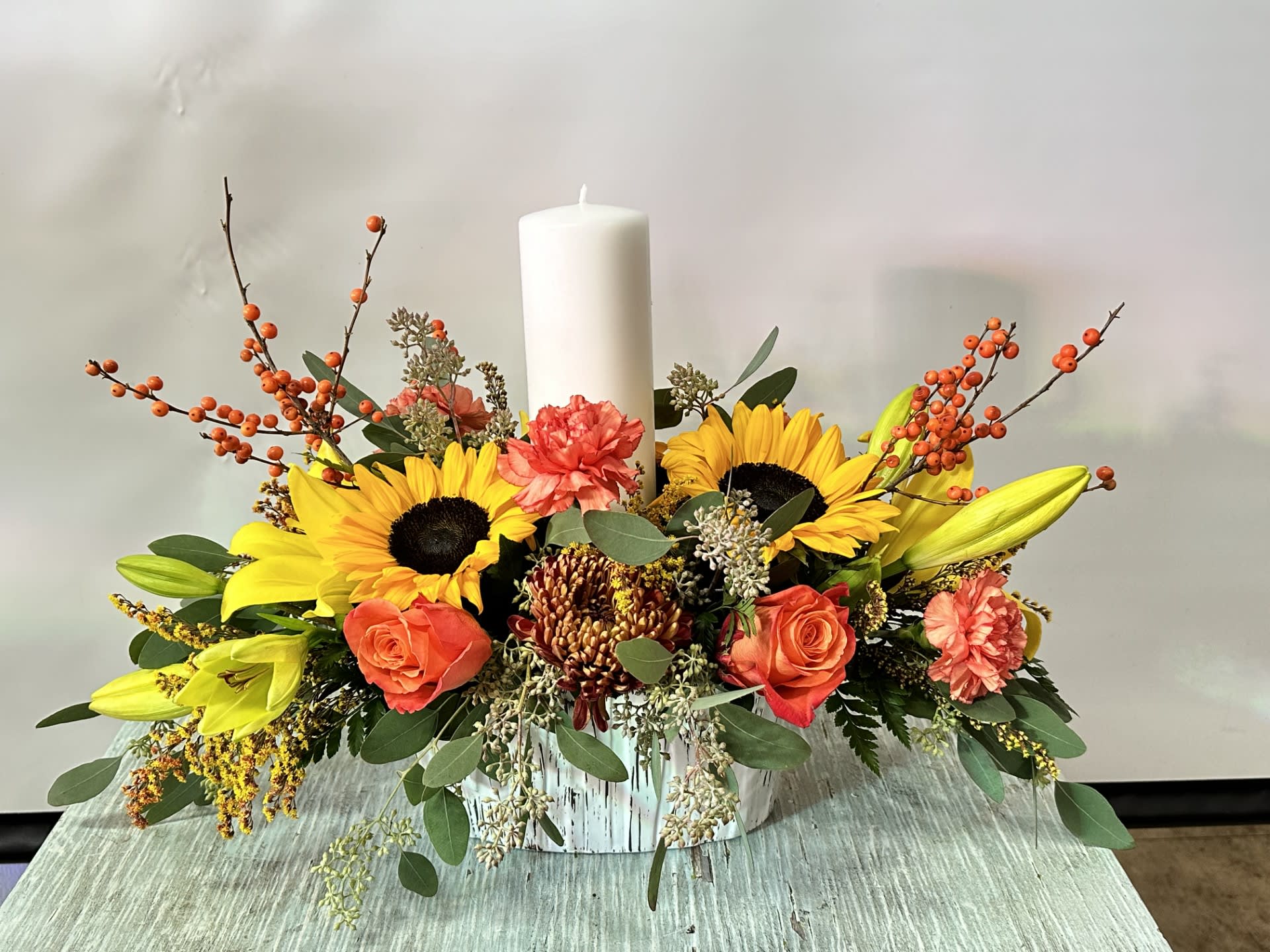 Autumn #8 - Arrangement in a ceramic container that includes candle. A perfect addition to your table for this thanksgiving. SAME DAY DELIVERY Please keep in mind we will try our best to make arrangement as similar as possible based on availability if a flower must be substituted we will keep arrangement within the same color scheme. 