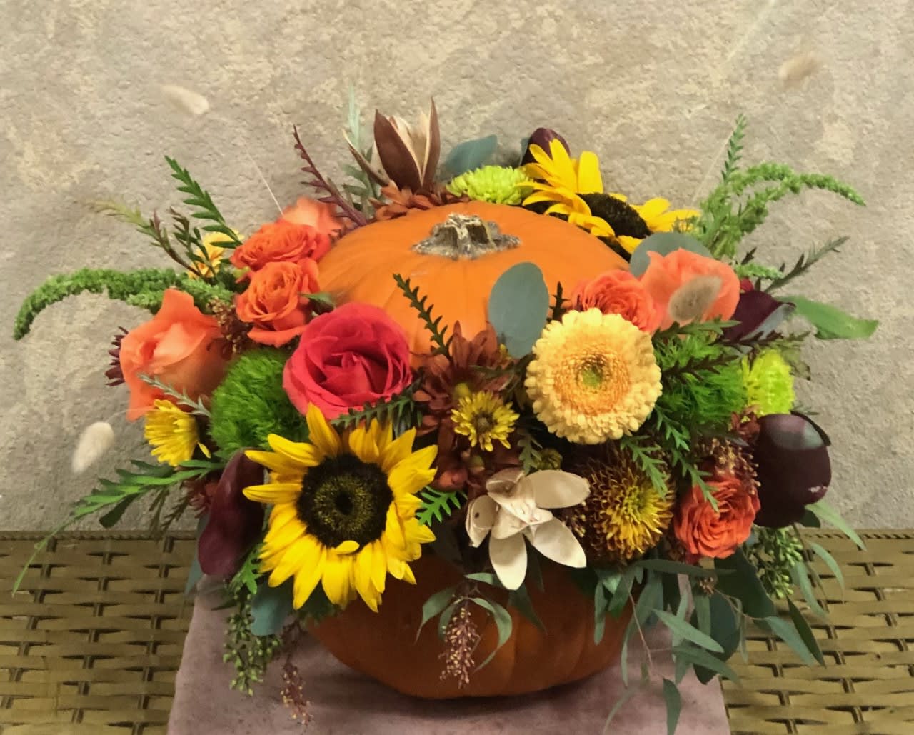 Fresh Harvest in Natural Pumpkin - Type of Flowers: Yellow Gerberas, Sunflowers, Pink and Orange Roses, Orange Spray Roses, Fall Colored Daisies and more in a natural pumpkin. Availability: All year round Substitute Available: Yes Design View: All Facing View Photo shown: Regular