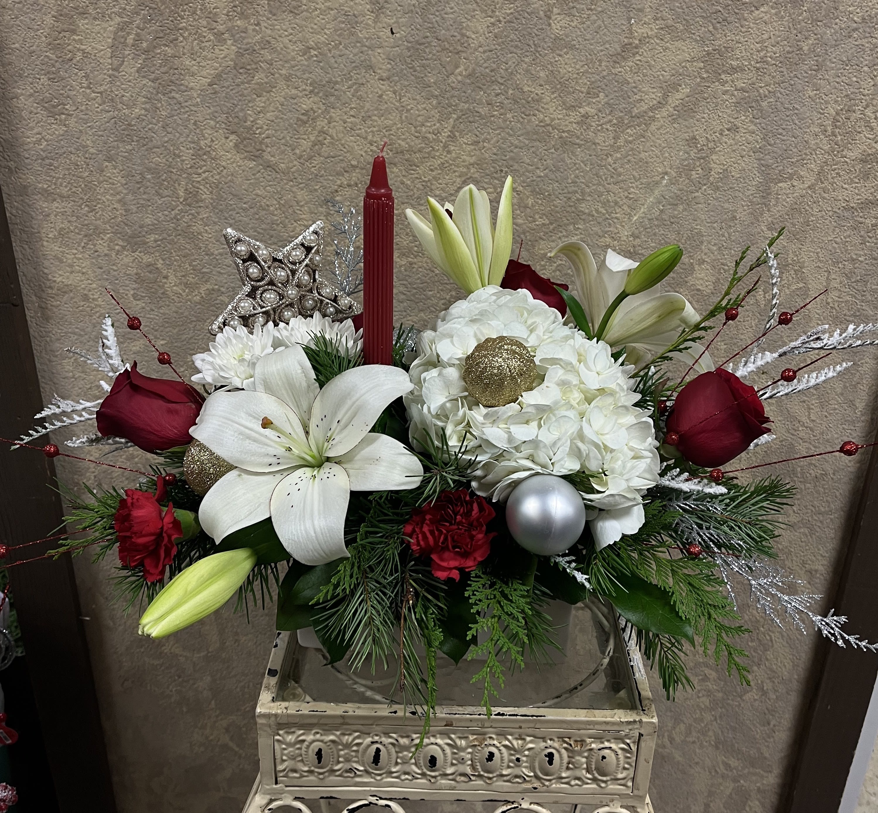 Holiday Dinner Party Centerpiece - Recipe: Red Roses, White Lilies, White Hydrangaes, Red Carnations, White Chrysthemums, with a red candle and ornaments in a rectagular white vase. Availability: All year round Design View: All Facing View Photo shown: Standard