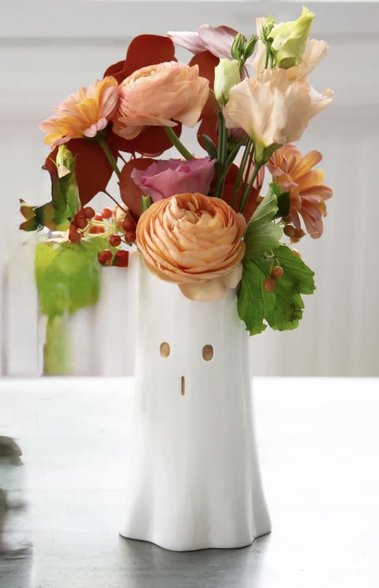 Hauntingly Familiar - Hauntingly Familiar is a cute 7&quot; white ghost vase with little gold eyes. Filled with the most beautiful seasonal flowers (colors vary by what's in stock.) Don't let this cutie be only used for Halloween. Wonderfully displaced on a counter or ledge. Cutest on a coffee table or corner nook.