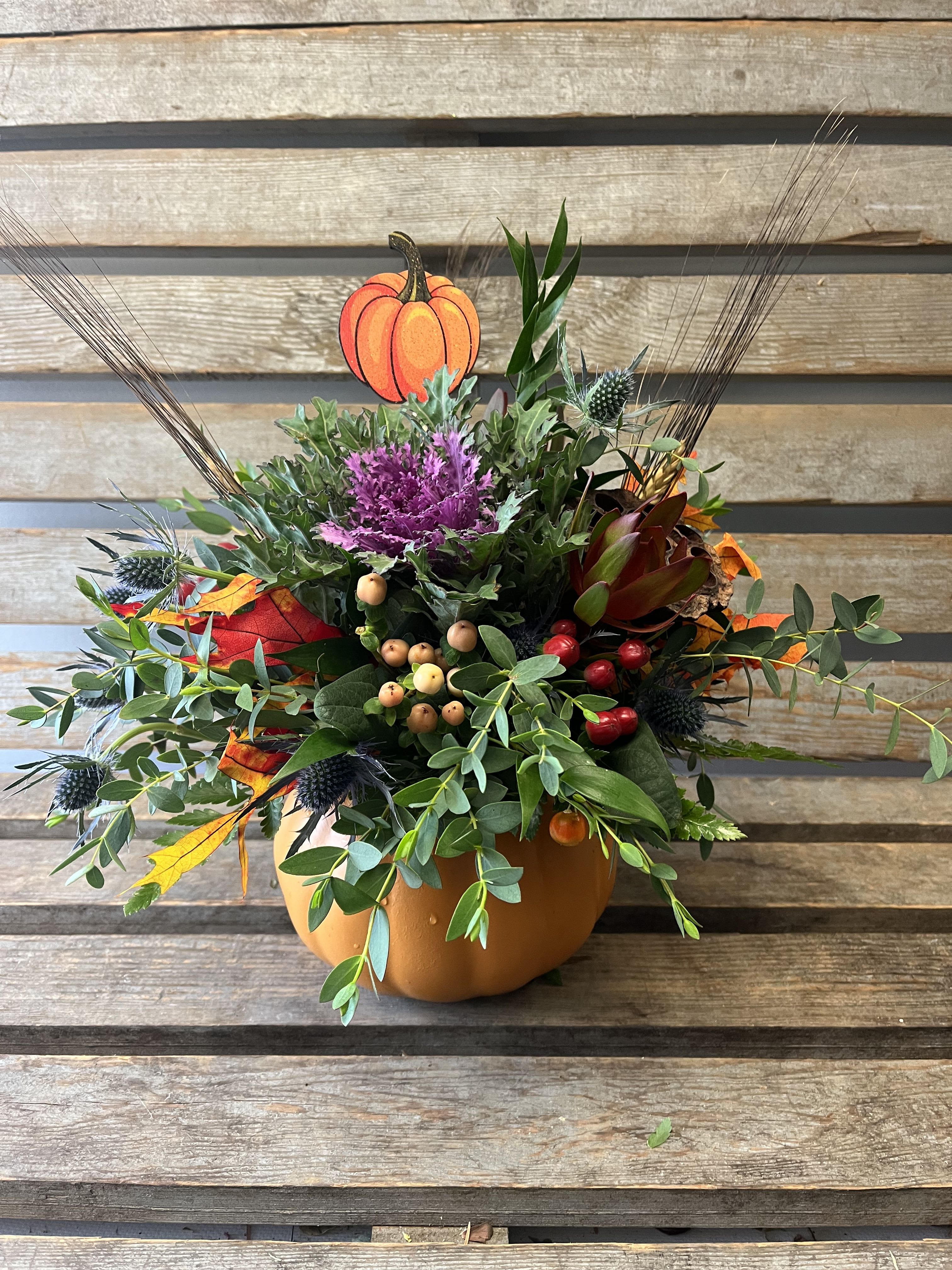 Autumn pumpkin  - Our autumn pumpkins are back. Ceramic pumpkin, filled with seasonal fall greenery with pops of berries , safari sunset, wheat , leaves and kale. Add an adorable pumpkin pick and it's perfect for your thanksgiving table! 