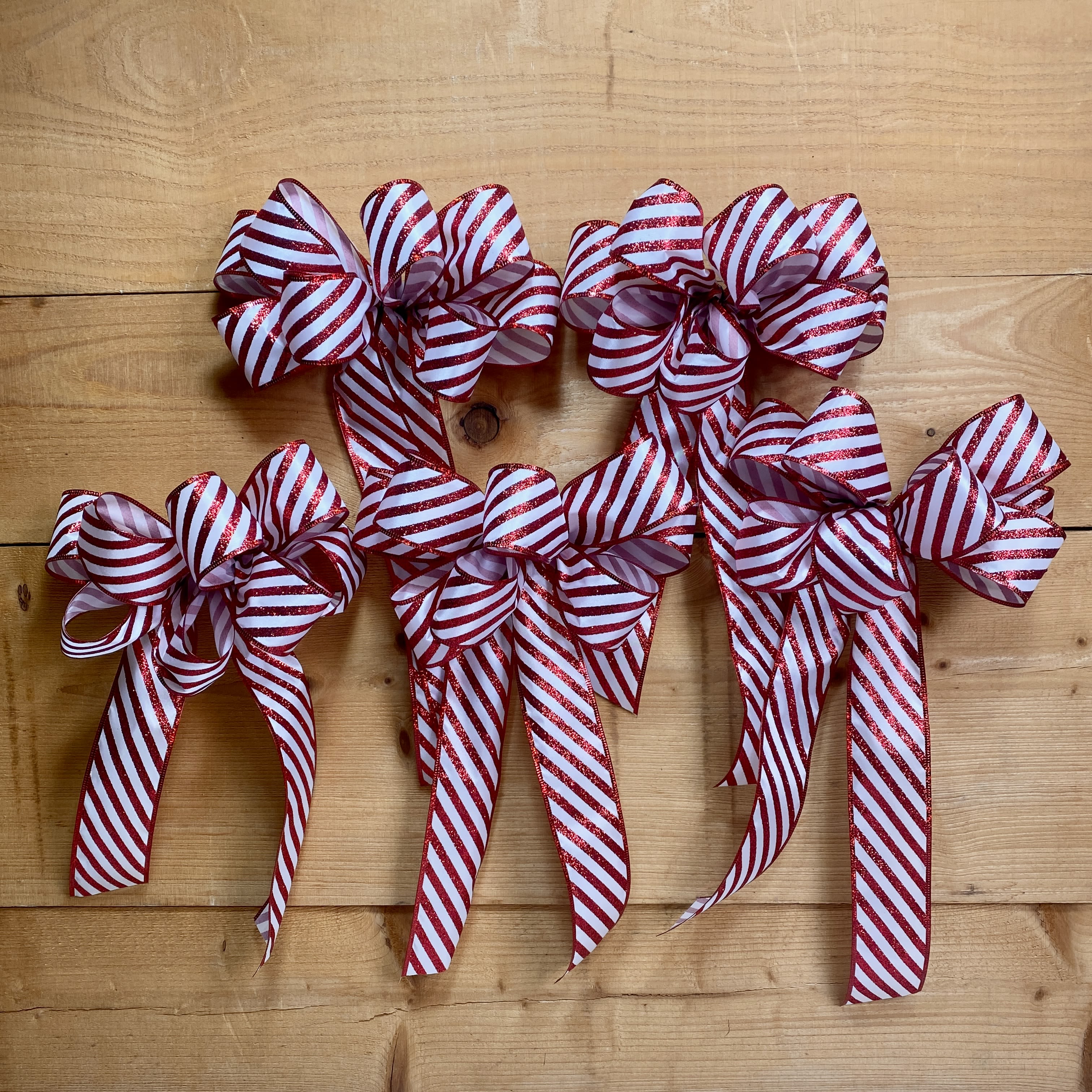 Bow Bundle - Candy Cane - Let us help you deck the halls this holiday season with one of our Bow Bundles! Each bundle comes with 5 premade bows, wired for your convenience so you can easily attach them wherever you want to decorate! Decorating just got so much easier with our Bow Bundles!