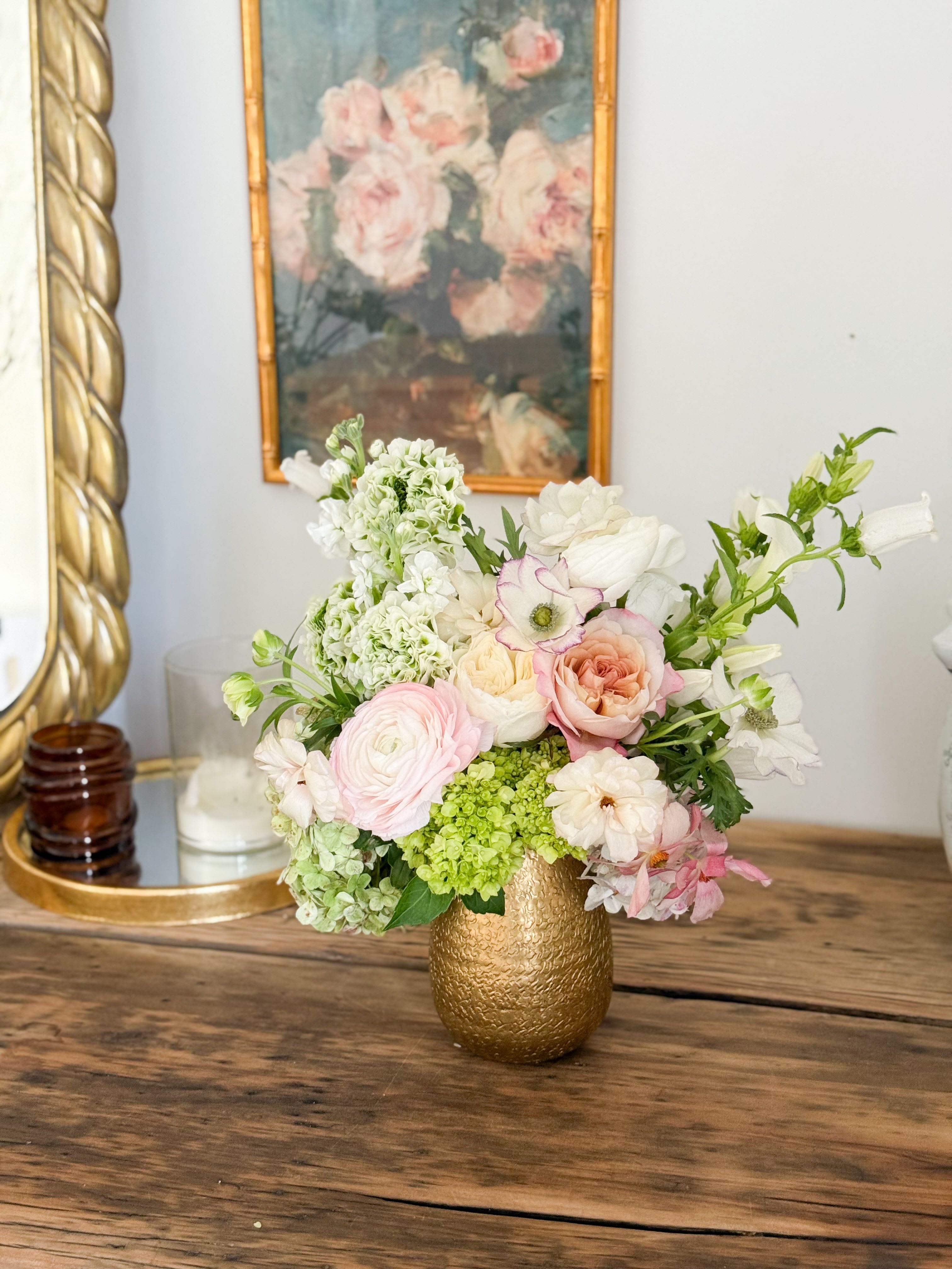 Camilla  - A seasonal lush mixed arrangement filled in a gold vase.   