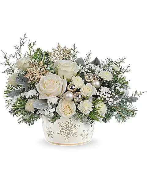 Teleflora's Starry Snowflakes Bouquet - Create unforgettable holiday memories with this special delivery of classic Christmas roses, elegantly presented in a hand-painted, distressed serving dish centerpiece adorned with a charming snowflake design. Perfectly food-safe, it adds a festive touch to your seasonal celebrations. The Starry Snowflake Centerpiece showcases white roses, spray roses, and button spray chrysanthemums, accented with sinuata statice and gypsophila. Designed with dusty miller, noble fir, white pine, and cedar, presented in the Snowflake Symphony Dish, it creates a timeless holiday centerpiece.