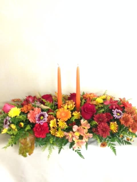 Seasonal Centerpiece with candles - An extra large oblong centerpiece filled with fall flowers, wheat, leaves and candles.