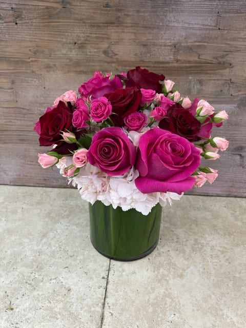 Amore Mio: A Symphony of Assorted Pink, Red Roses, and Hydrangeas - Step into a garden of passion and tenderness with the &quot;Amore Mio&quot; arrangement, a mesmerizing symphony of assorted pink and red roses intertwined with the lush beauty of hydrangeas. This arrangement captures the essence of deep affection and heartfelt emotions, blending the timeless allure of roses with the soothing presence of hydrangeas. As a testament to love's diverse expressions, &quot;Amore Mio&quot; paints a canvas of romance and devotion. &quot;Varieties and colors of flowers may vary according to season and availability.&quot;  This arrangement includes a newly cleaned vase and good quality water &amp; flower food.  Item: 172  Care Instructions: For the best vase life, change the water every two days.