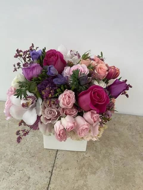 Beauté Enamour: A Captivating Arrangement Celebrating Beauty and Love - In the realm of emotions, the fusion of beauty and love creates a tapestry that enchants hearts and captivates souls. The &quot;Beauté Enamour&quot; arrangement celebrates this exquisite union, where each bloom is carefully chosen to represent the harmony of love's affection and the allure of aesthetic wonder. Join us as we delve into the bouquet's petals, where beauty and love intertwine in a mesmerizing dance.  &quot;Varieties and colors of flowers may vary according to season and availability.&quot; This arrangement includes a newly cleaned vase and good quality water &amp; flower food.  Item: 413  Care Instructions: For the best vase life, change the water every two days.