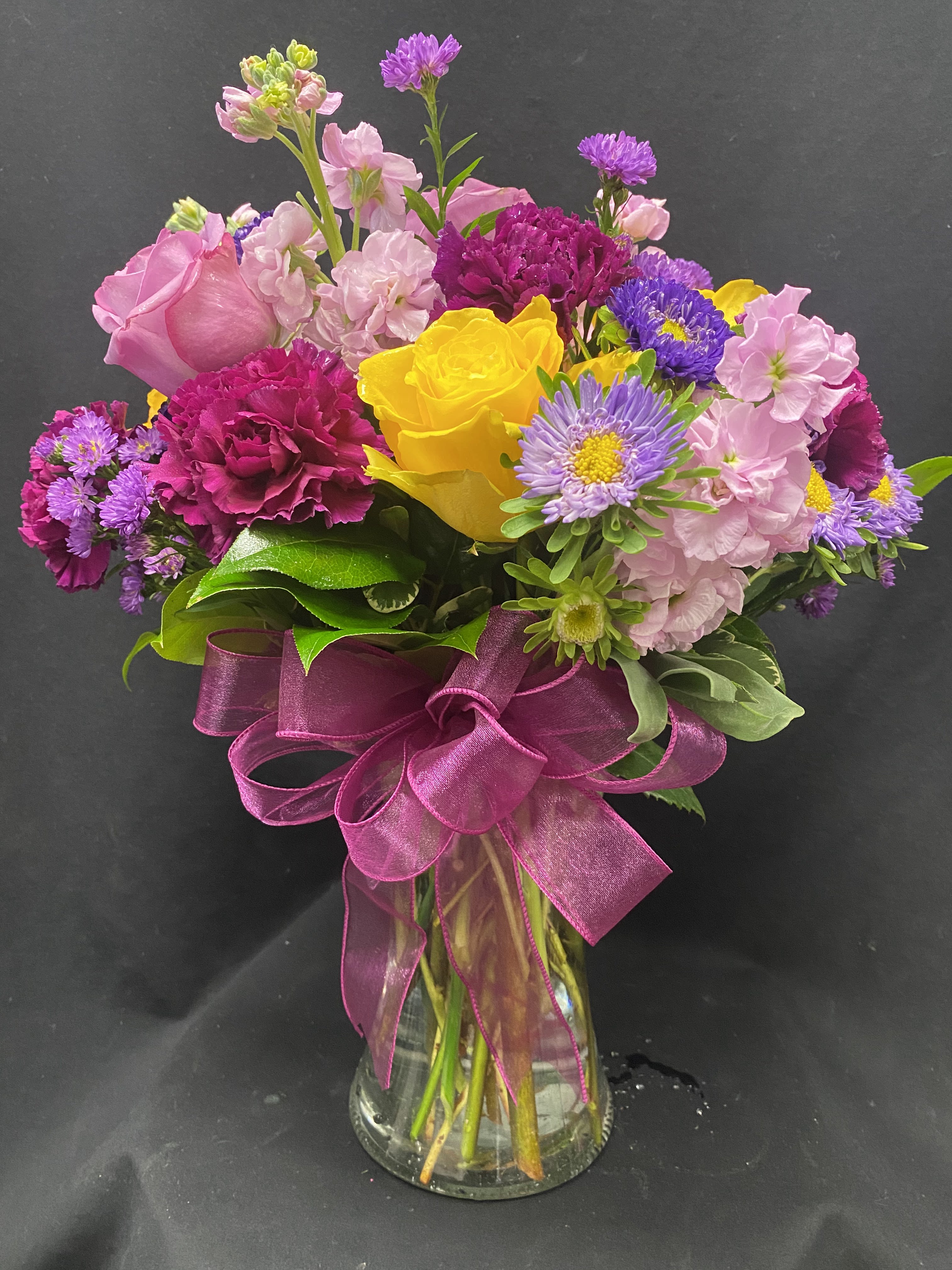 Surprise! - clear vase roses, stock, asters, carnations, monte casino and greens