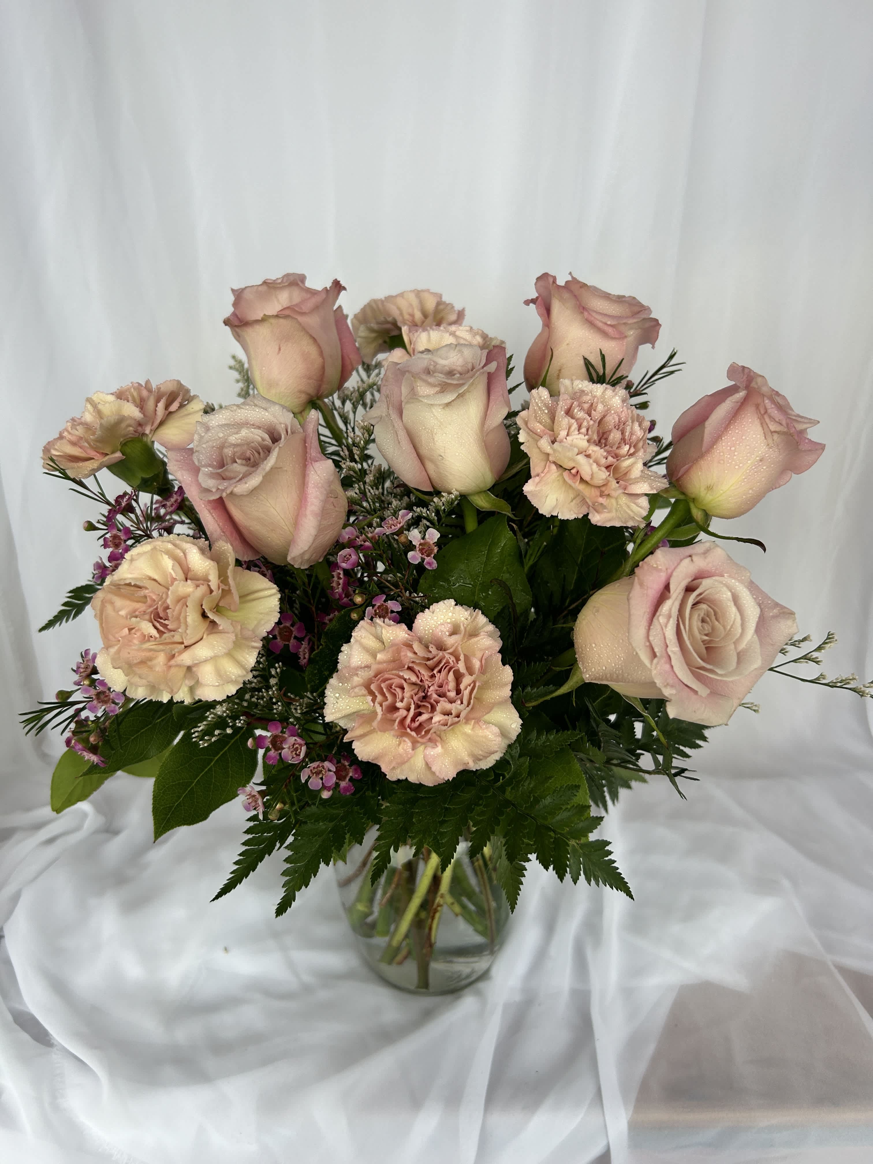 Sugar and Spice - Roses and carnations in a vase with greens and filler!  Simple and beautiful.  Call shop to make sure what color roses and carns we'll be using.  (We'll try to use red and pink, but our flower inventory constantly changes.)