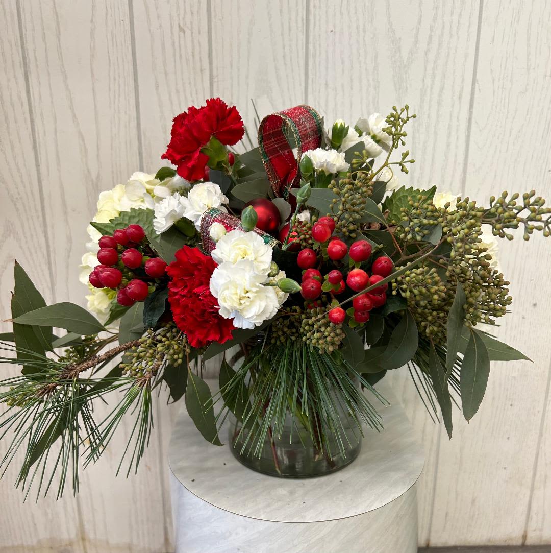 Enchanting Holiday - This clear glass cylinder is filled with holiday favorites &amp; fragrant evergreens.  Approx. 11 inches high.  The deluxe &amp; premium include roses.