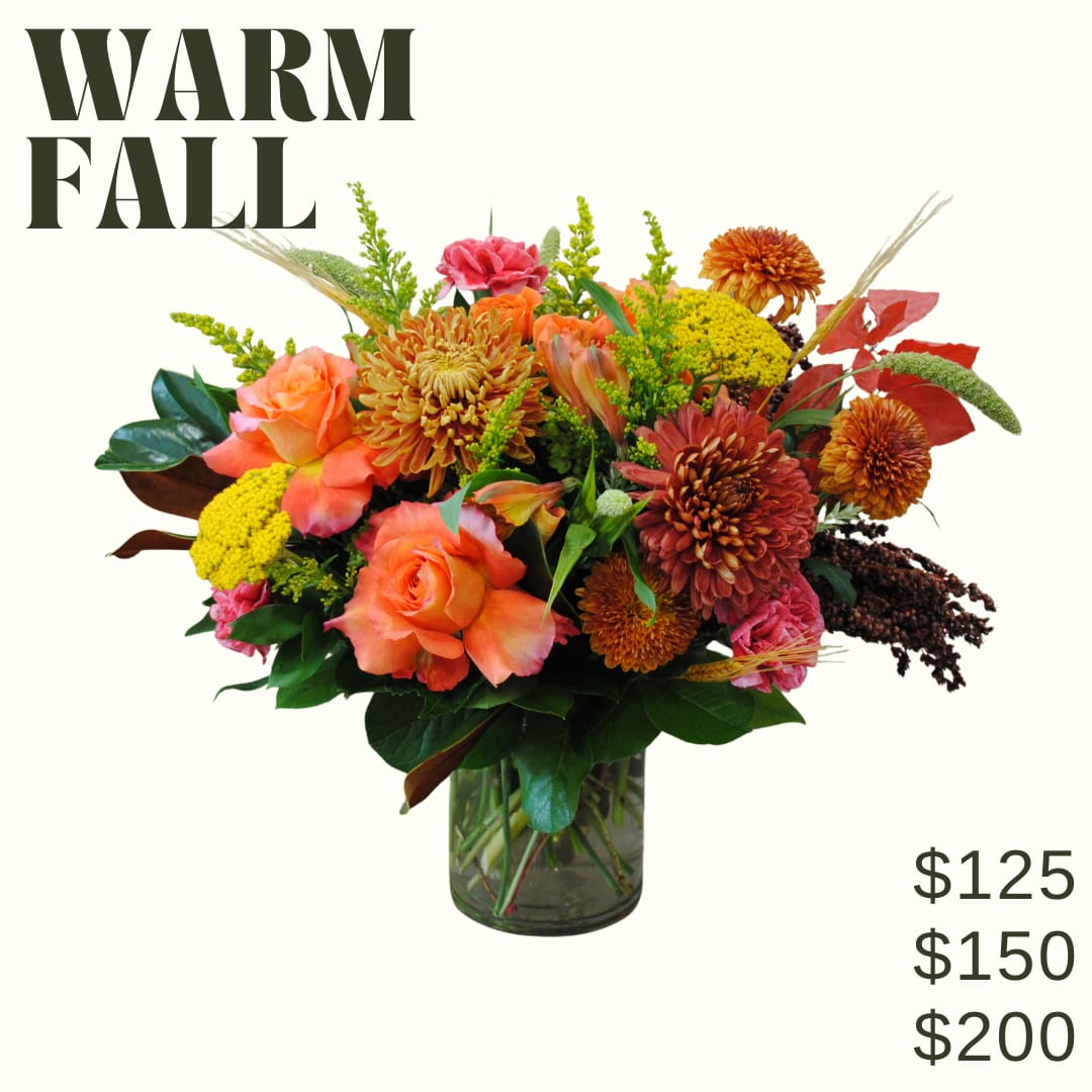 Warm Fall Bouquet - Warm Fall is a low and lush bouquet artfully designed in a clear glass vase using warm toned fall blooms!  *Image shown is valued at $150 *The $125 and $200 price points will be made with more or fewer flowers to match the value using blooms in the same color palette