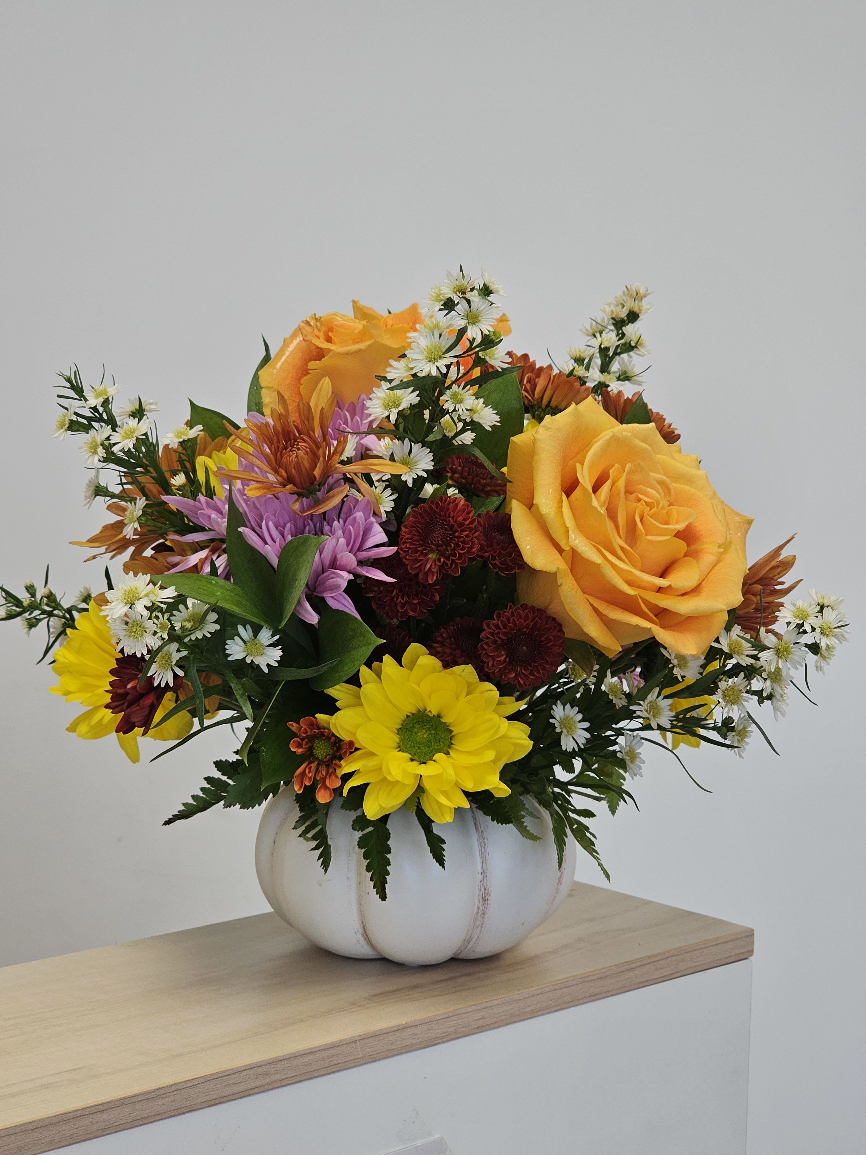 Sweet Pumpkin - Bring home the beauty of the harvest season with this Sweet Pumpkin. This charming arrangement features bright sunflowers, roses, and tropical safari accents in a pumpkin vase. This pumpkin is the perfect pick-me-up for a friend or loved one in need of a smile. 