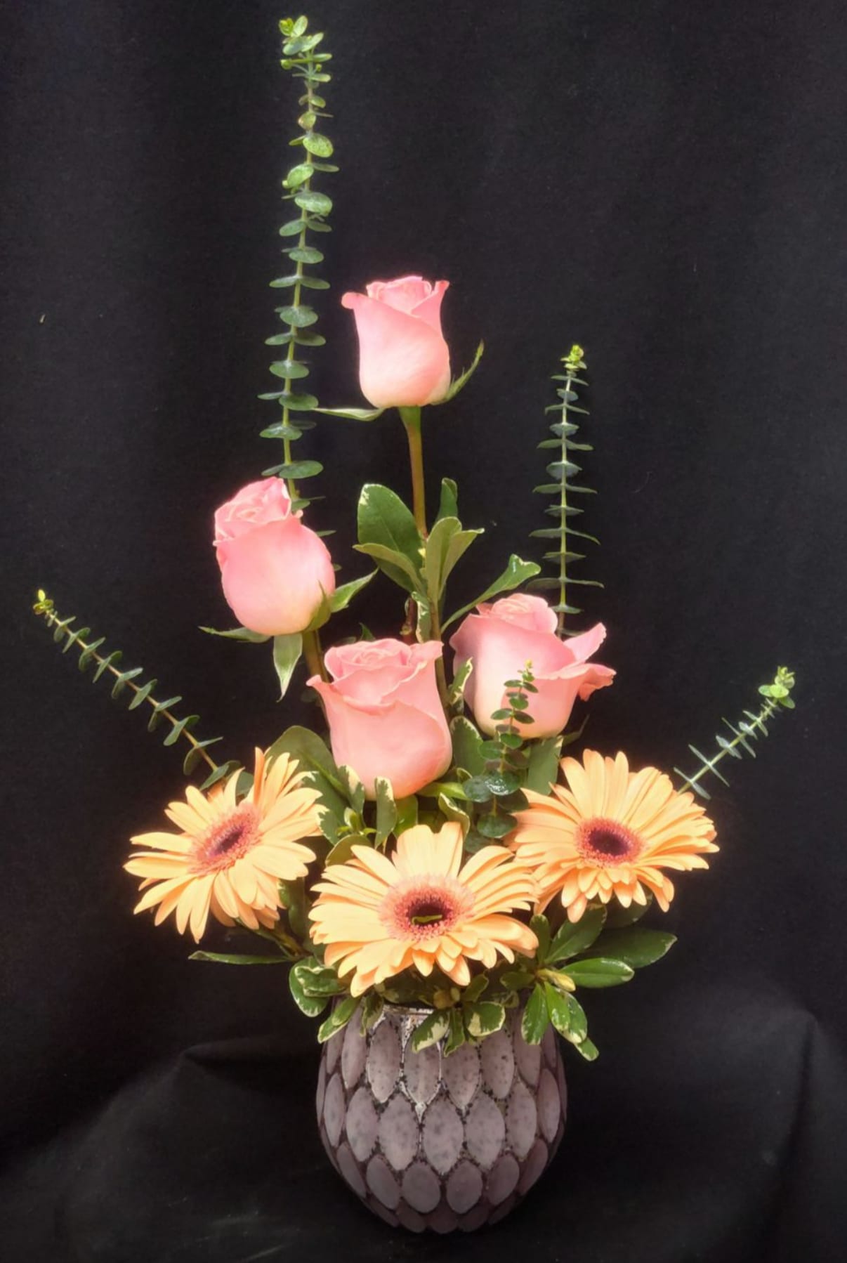 My eyes on you - Lavender ceramic with 3 peach and 4 pink roses high style with mixed greens