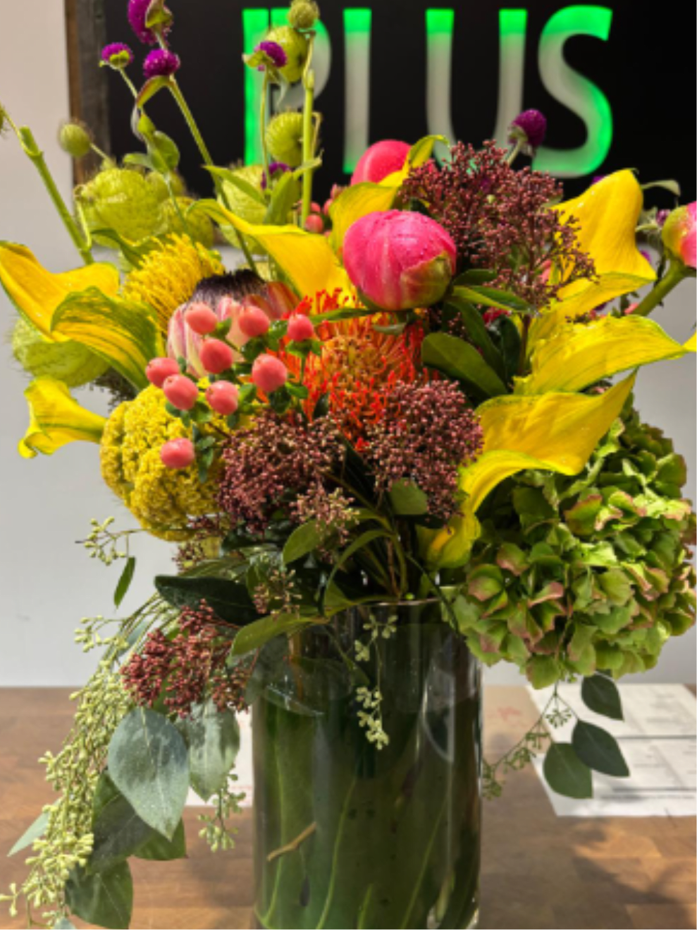 Winter 2 - A vibrant winter mix featuring exotic protea, calla lilies, burgundy skimmers &amp; lush seasonal greens. This arrangement brings warmth and color to cold days.