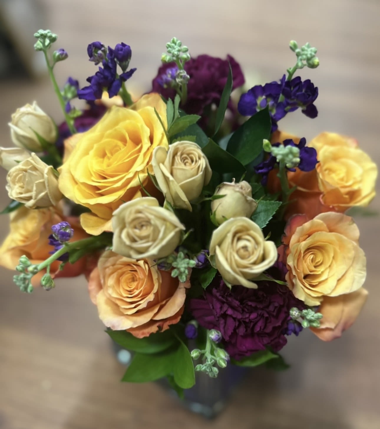 VIBRANT JEWELS PURPLE CUBE BOUQUET - A VIBRANT BOUQUET OF ROSES, SPRAY ROSES, STOCK, AND CARNATIONS IN A PURPLE CUBE UNIQUE COLOR COMBINATION- SURE TO BRING A SMILE