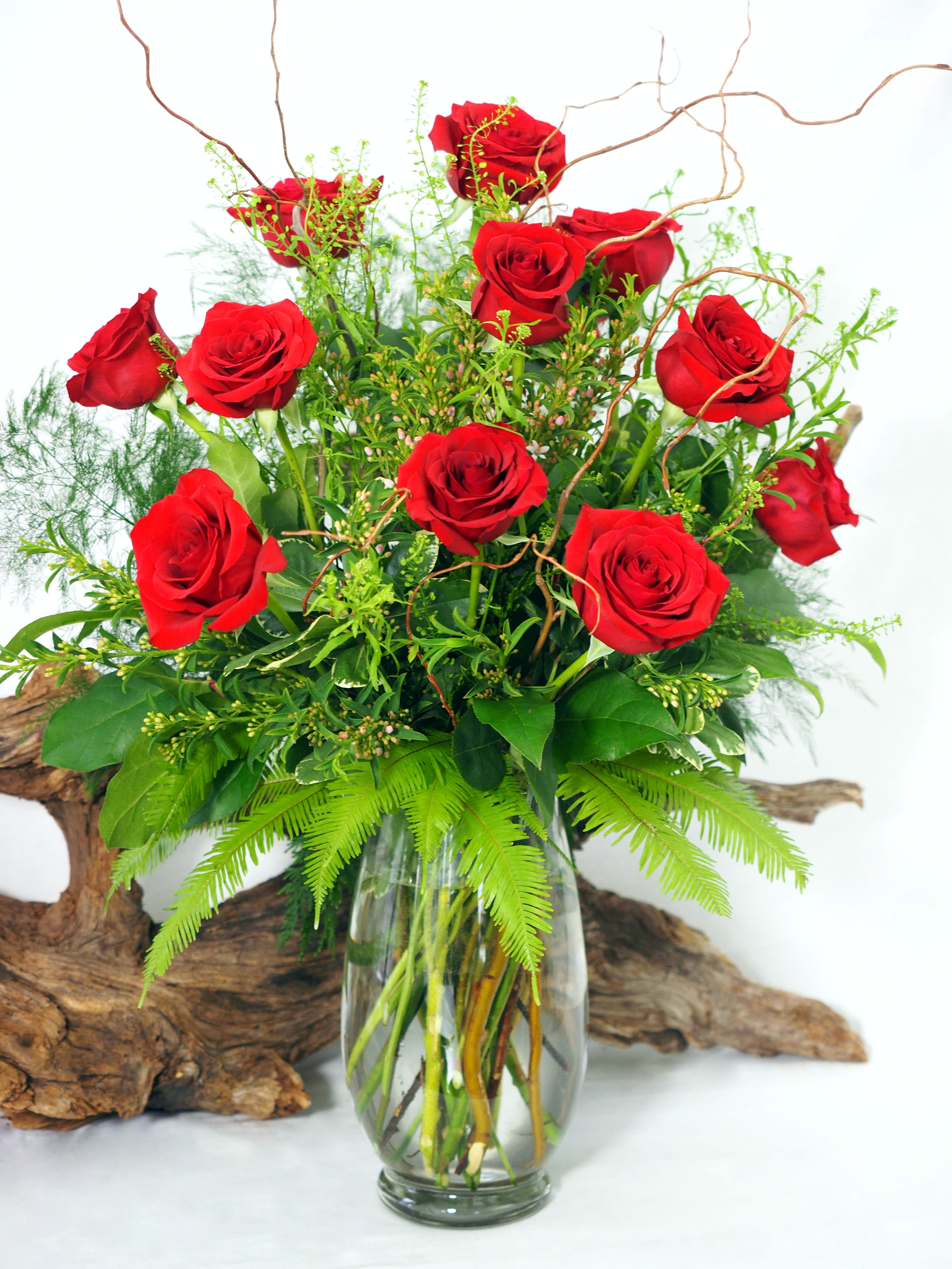 Timeless Romance - Classic. Romantic. Elegant.   Timeless Romance...the name says it all. Express your love with an impressive display of a dozen premium long-stemmed red roses arranged with delicate accent flowers and lush mixed greenery. More roses, greens, and accent flowers are added for the deluxe and premium options for an even greater display.   Deluxe includes 18 long-stemmed roses and our premium option features 24 long-stemmed roses.   In the language of flowers red roses symbolize love, desire, passion and respect. If you prefer another rose color, please let us know in the &quot;special requests&quot; section.   *SYMPATHY/FUNERAL: PLEASE NOTE THE TIME, PLACE, &amp; NAME OF THE DECEASED FOR THE SERVICE IN THE SPECIAL NOTES SECTION OF YOUR ORDER - WE ARE UNABLE TO GUARANTEE DELIVERY TIME WITHOUT THIS.*